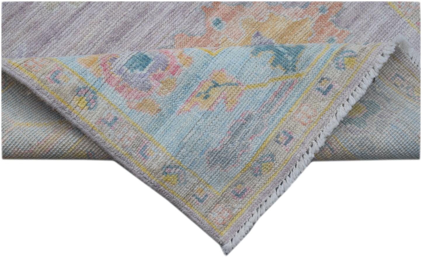 A handmade Afghan Oushak runner featuring a traditional pattern in soft pastel tones.
