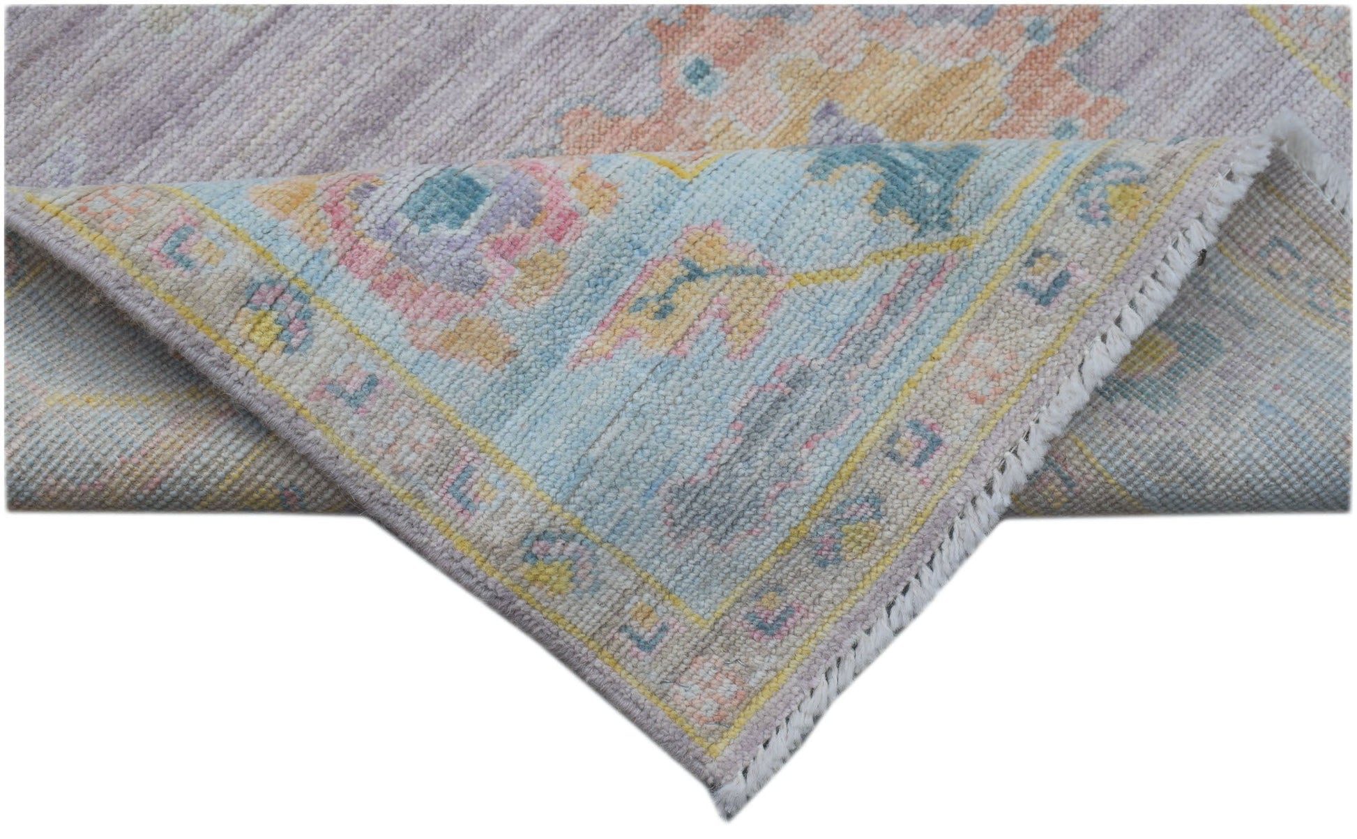 A handmade Afghan Oushak runner featuring a traditional pattern in soft pastel tones.