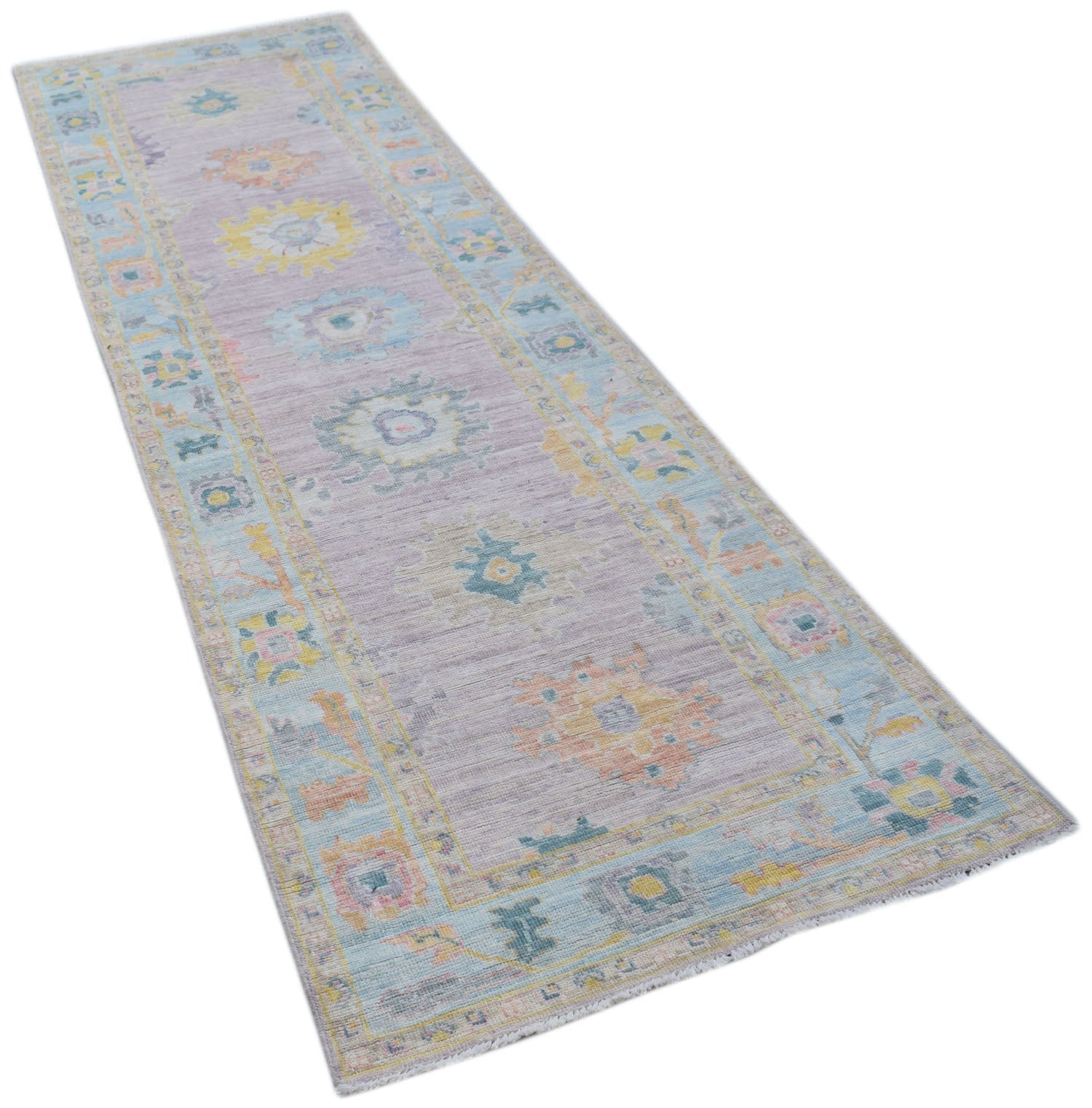 A handmade Afghan Oushak runner rug featuring a traditional pattern in soft pastel tones.