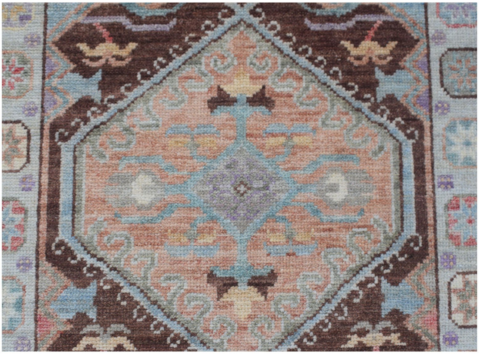 Handmade Afghan Oushak runner featuring a traditional diamond pattern in soft earth tones.