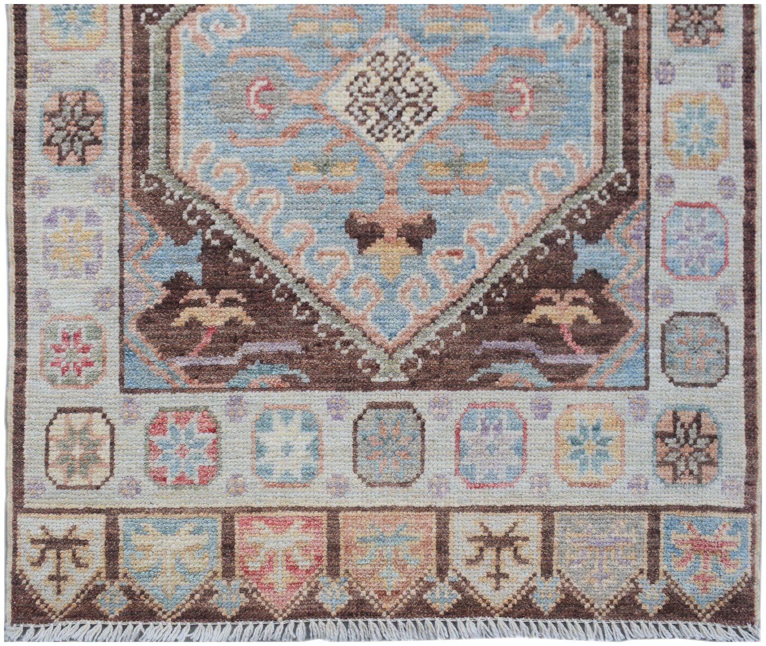 Handmade Afghan Oushak runner featuring a traditional geometric pattern in blue and brown tones.