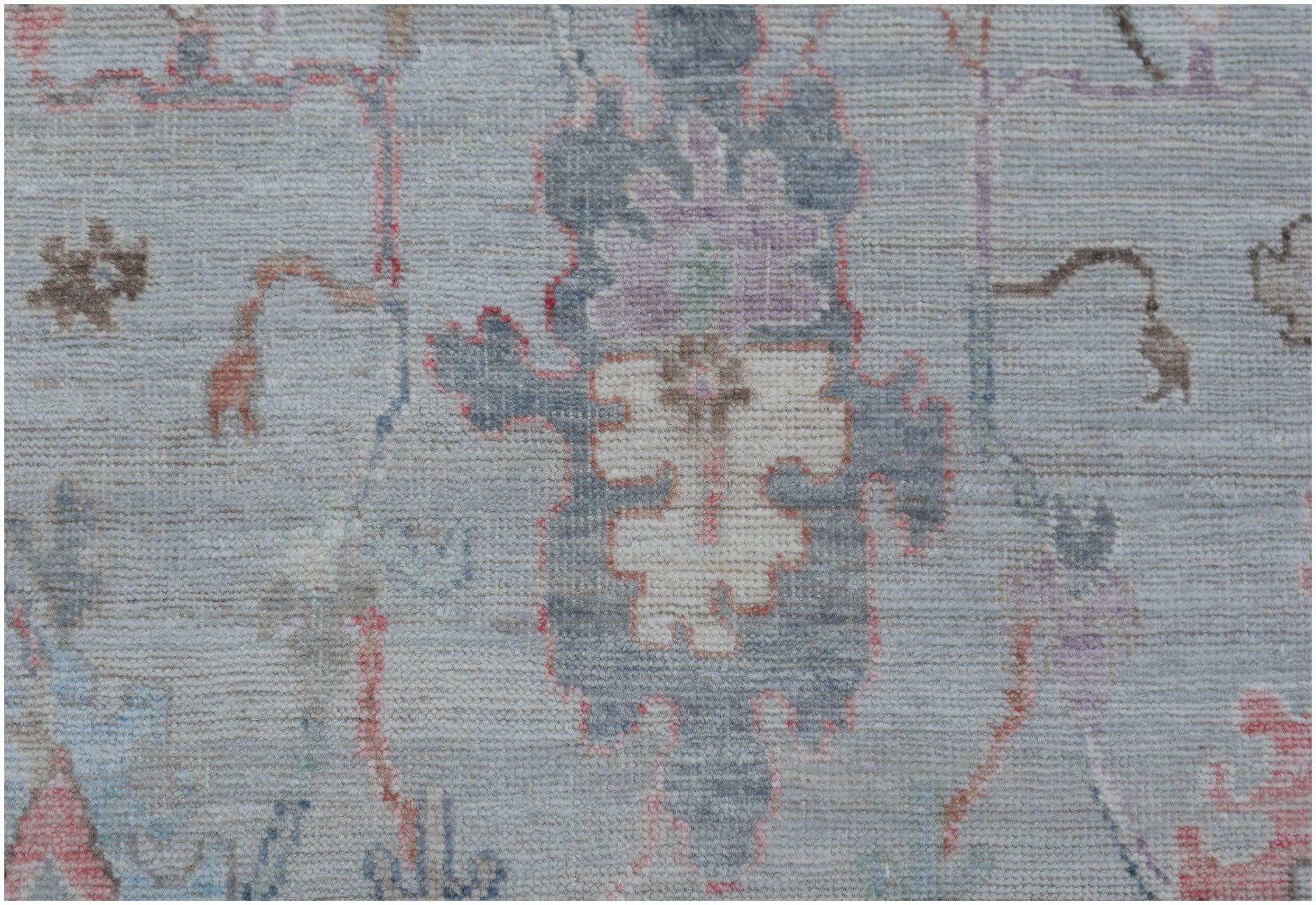 A handmade Afghan Oushak runner featuring a traditional pattern in soft, muted tones.