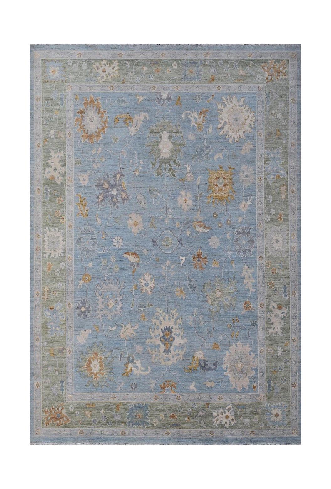 A handmade Afghan Oushak rug featuring a traditional floral pattern in blue, green, and gold tones.