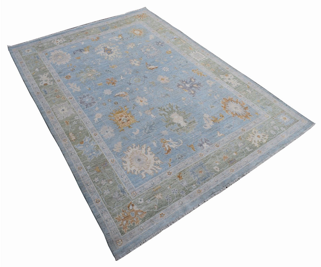 A handmade Afghan Oushak rug featuring a traditional floral pattern in blue, green, and gold tones.