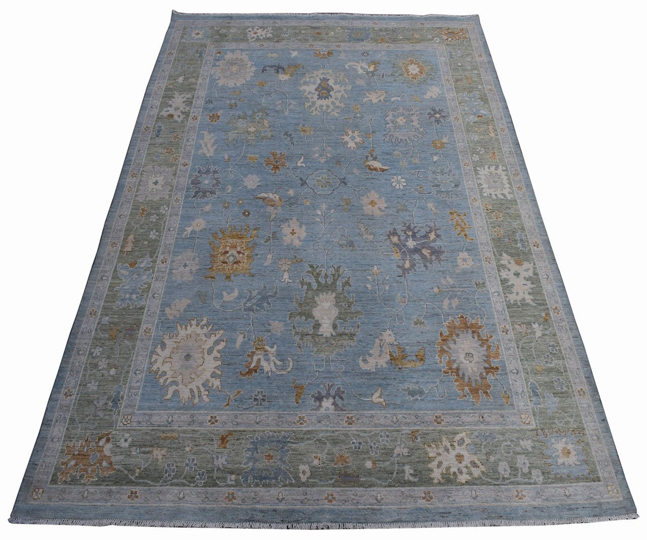 A handmade Afghan Oushak rug featuring a traditional floral pattern in blue, green, and tan tones.