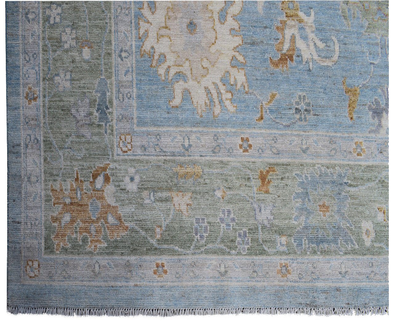 Handmade Afghan Oushak rug featuring a traditional floral pattern in blue, green, and tan tones.