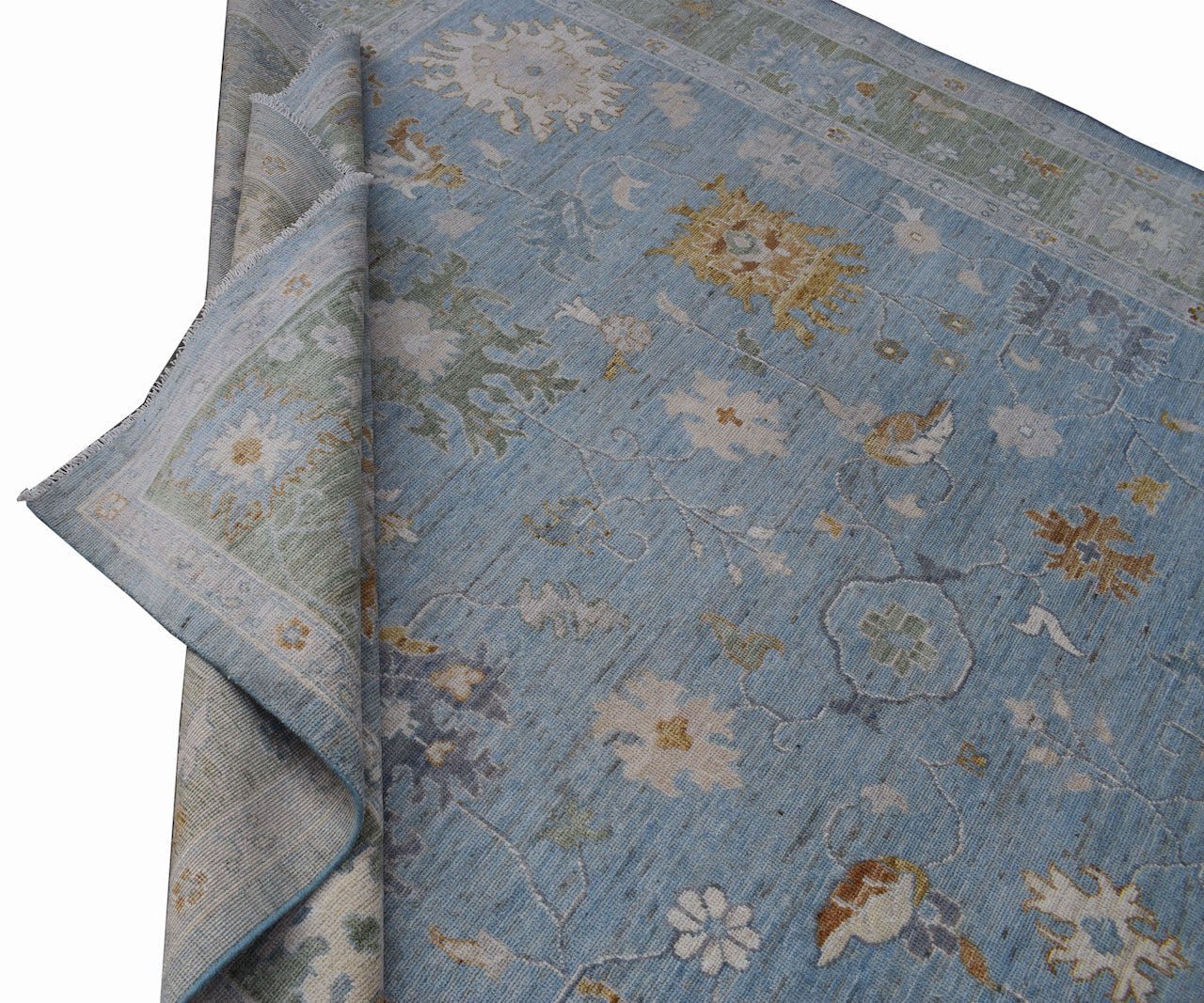 A handmade Afghan Oushak rug featuring a traditional floral pattern in shades of blue and gold.