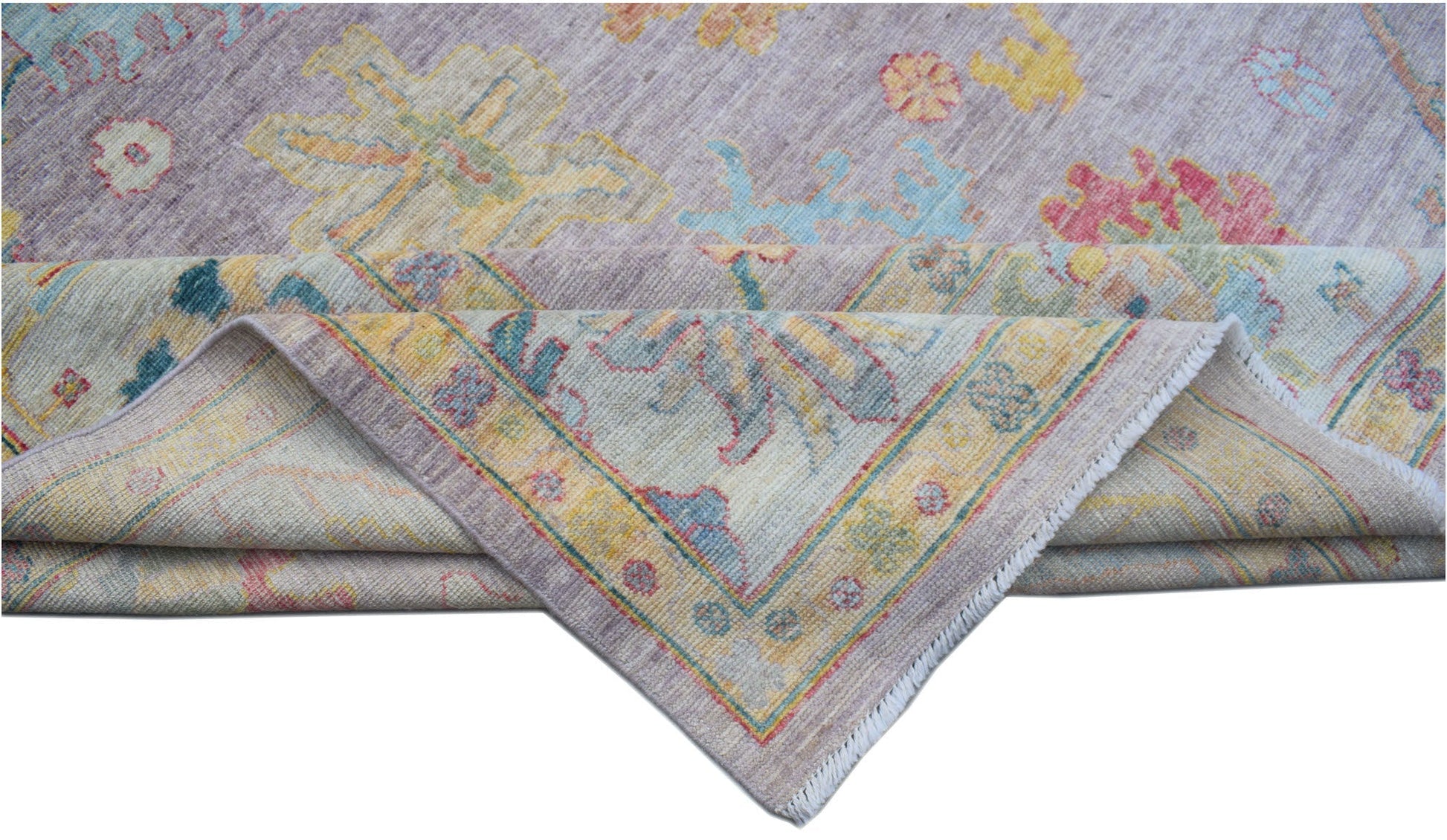 A handmade Afghan Oushak rug featuring a traditional floral pattern in soft, multicolored tones.