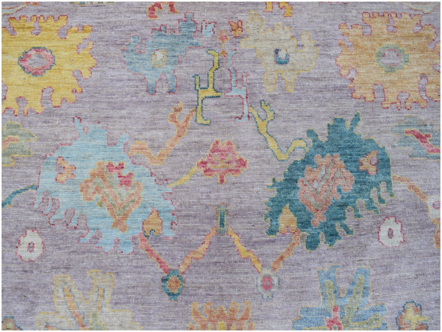 Handmade Afghan Oushak rug featuring a traditional floral pattern in soft, multicolored tones.