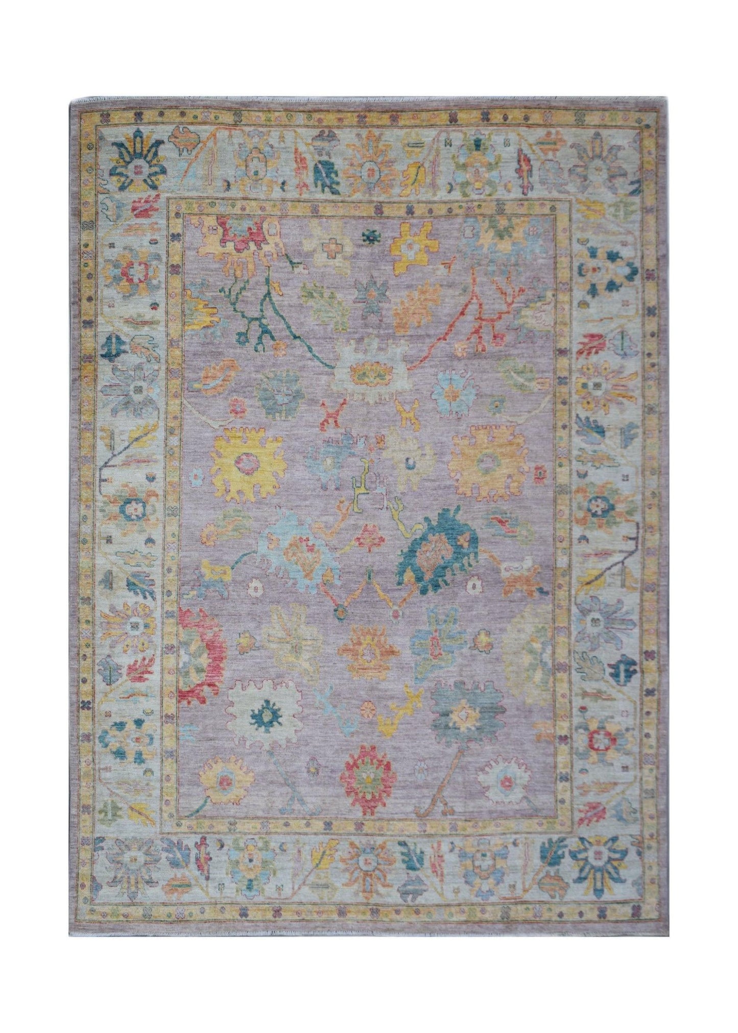 A handmade Afghan Oushak rug featuring a traditional floral pattern in a soft lavender colorway.