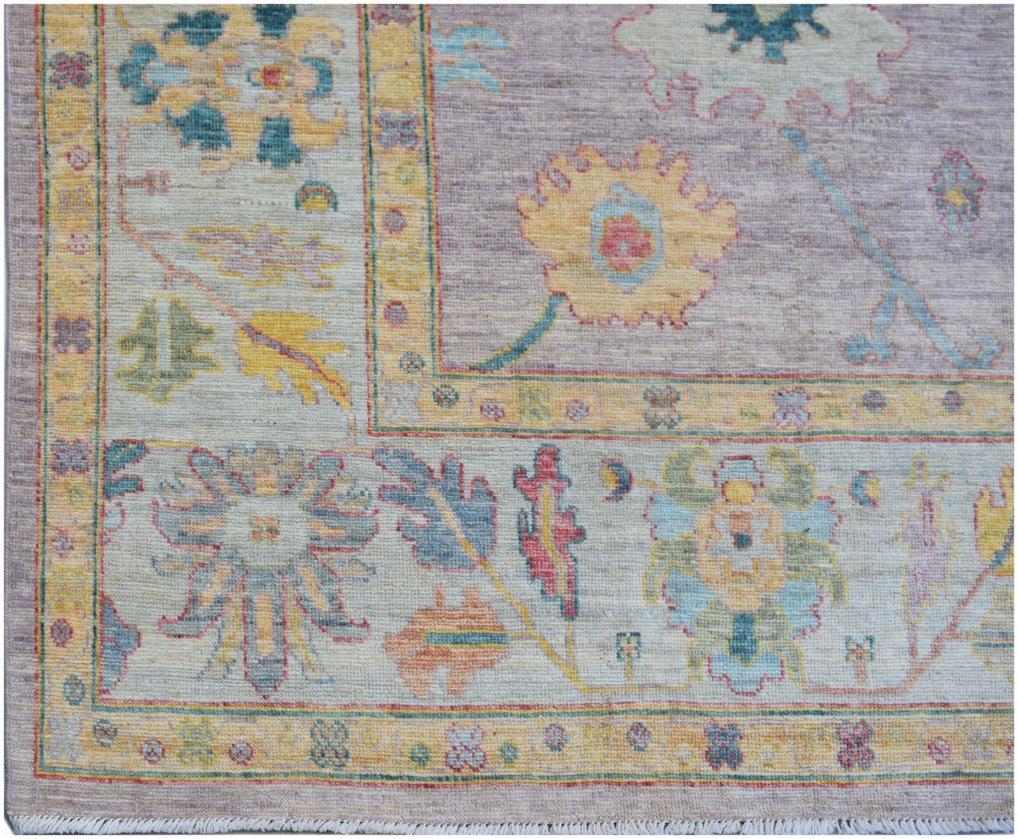 A handmade Afghan Oushak rug featuring a traditional floral pattern in soft pastel tones.