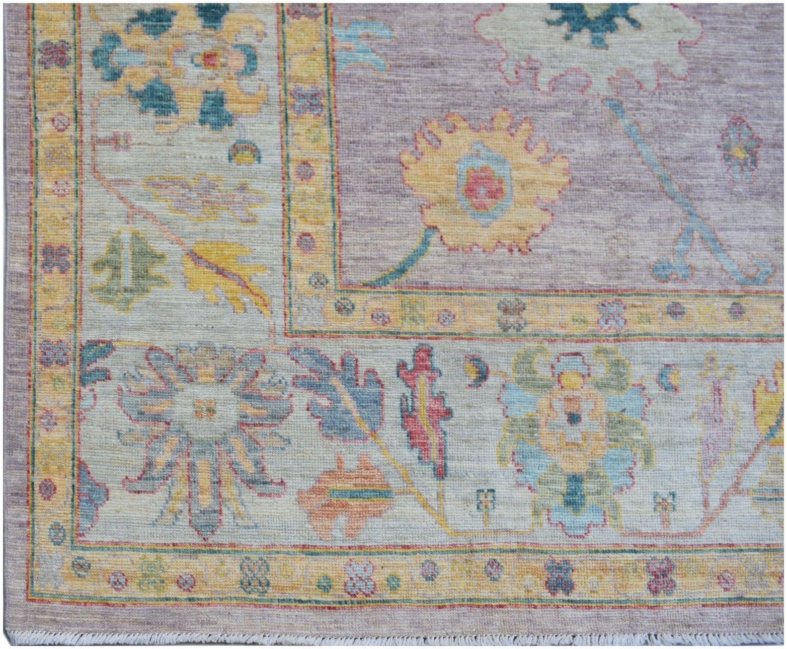A handmade Afghan Oushak rug featuring a traditional floral pattern in soft pastel tones.