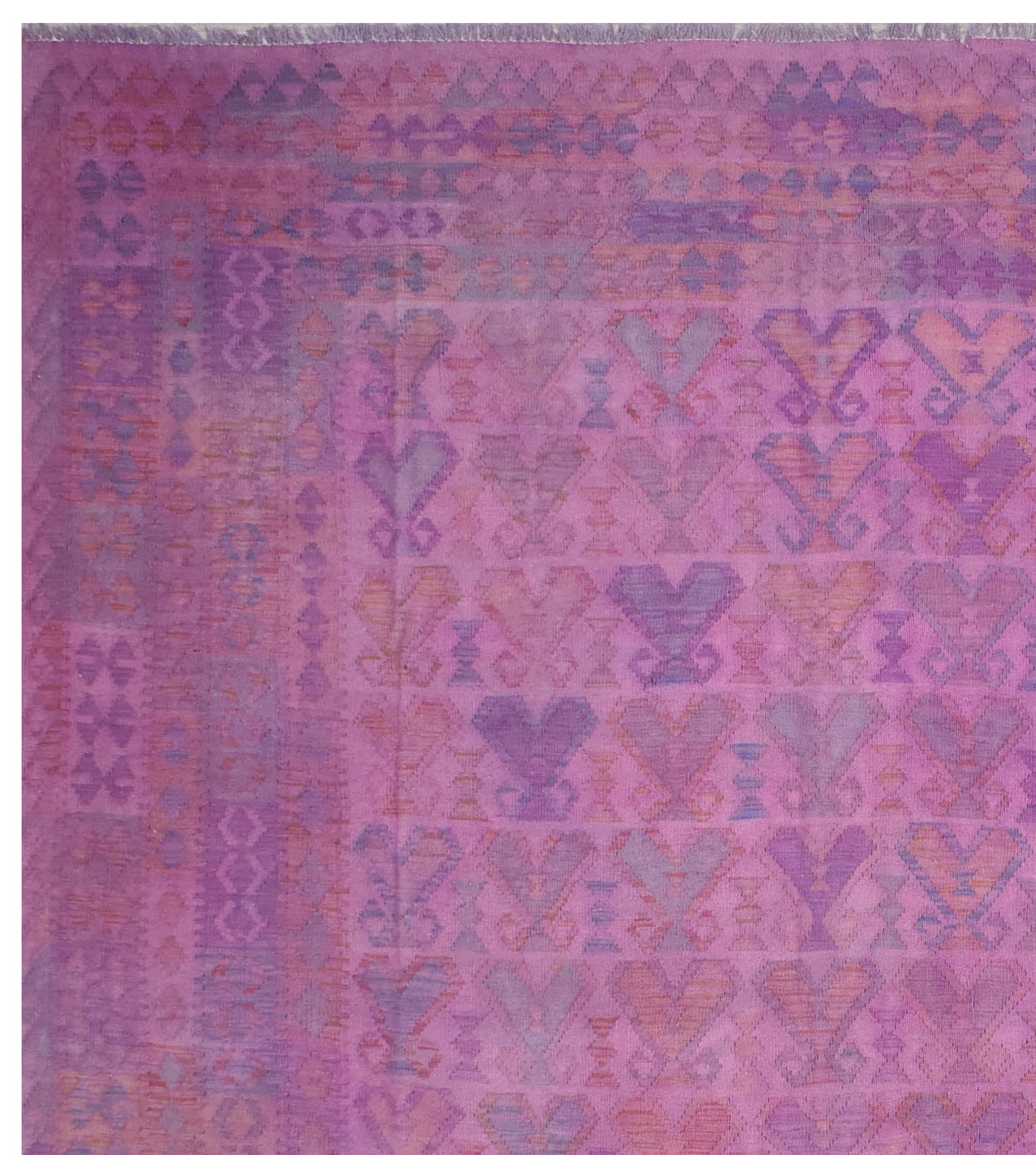 A handmade Afghan Maiamana kilim rug featuring a geometric pattern in shades of purple and pink.
