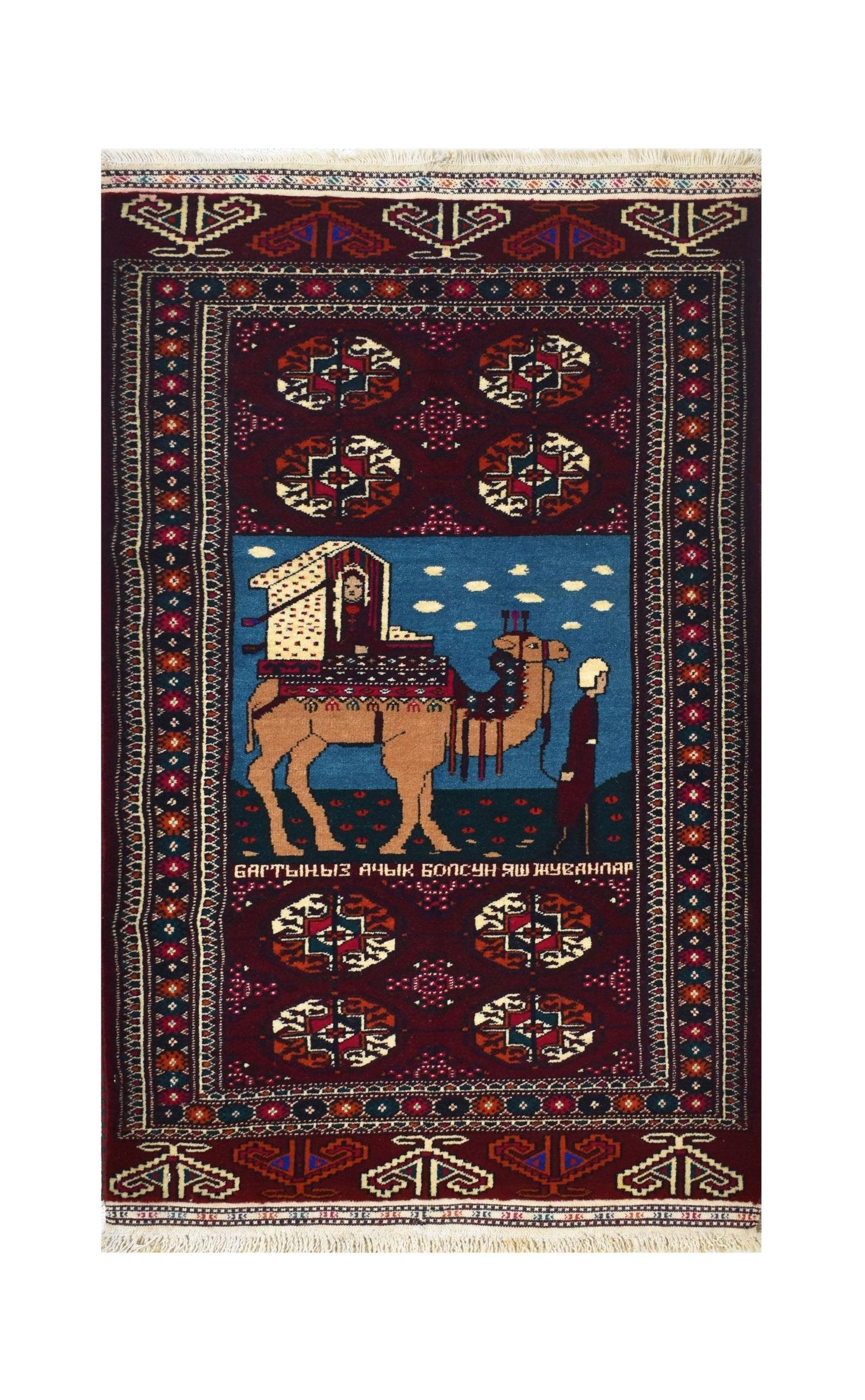 A handmade vintage Afghan Turkmen rug featuring a camel caravan scene on a deep red background.