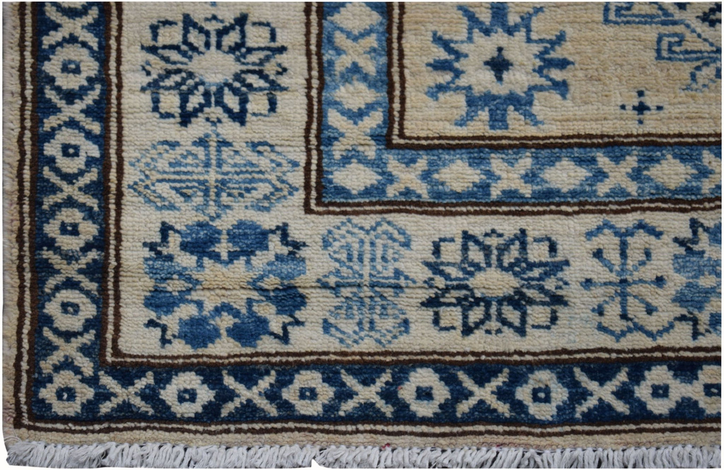 Handmade Afghan Super Kazakh runner rug featuring traditional blue geometric motifs on cream wool.