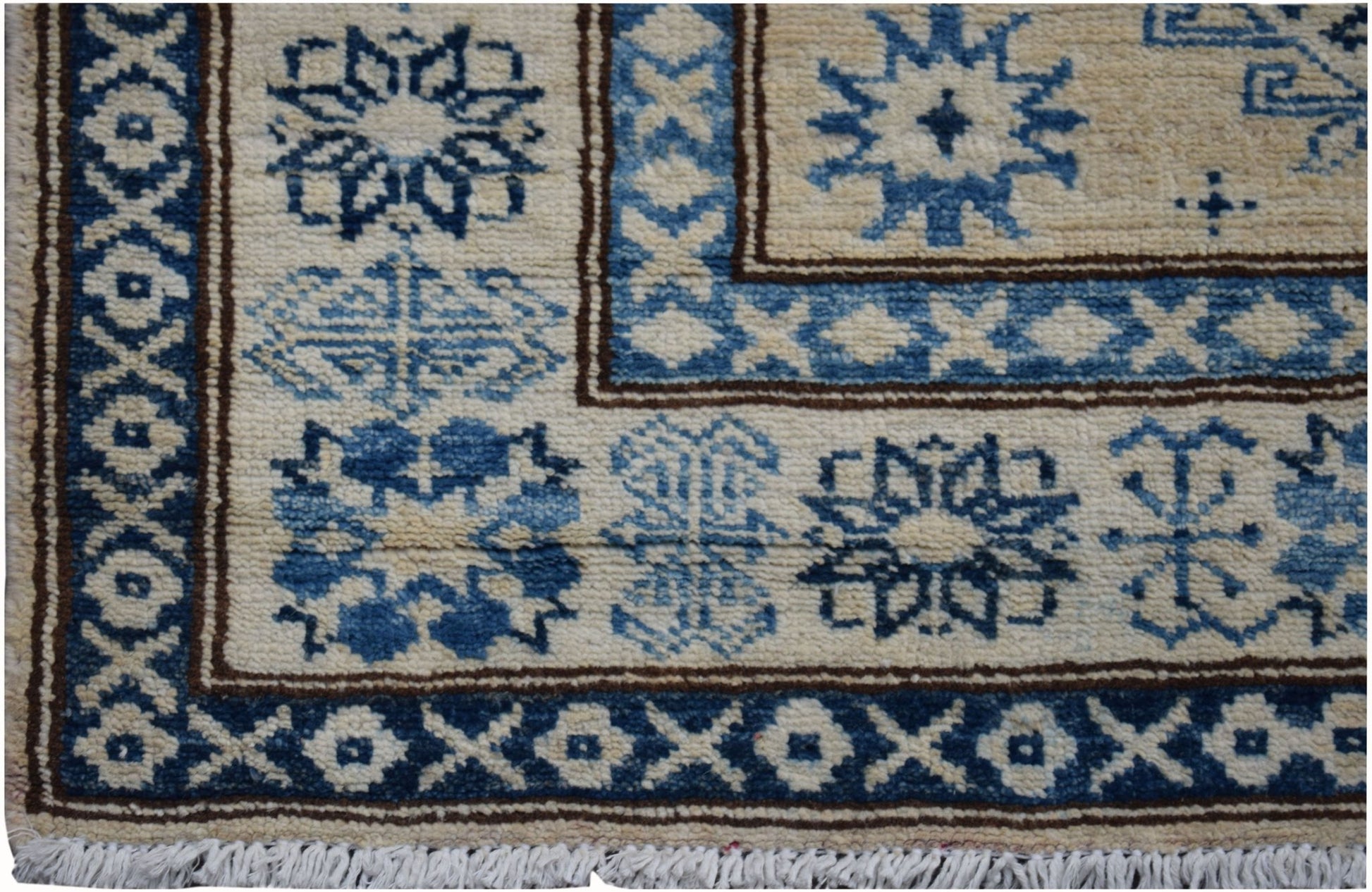 Handmade Afghan Super Kazakh runner rug featuring traditional blue geometric motifs on cream wool.
