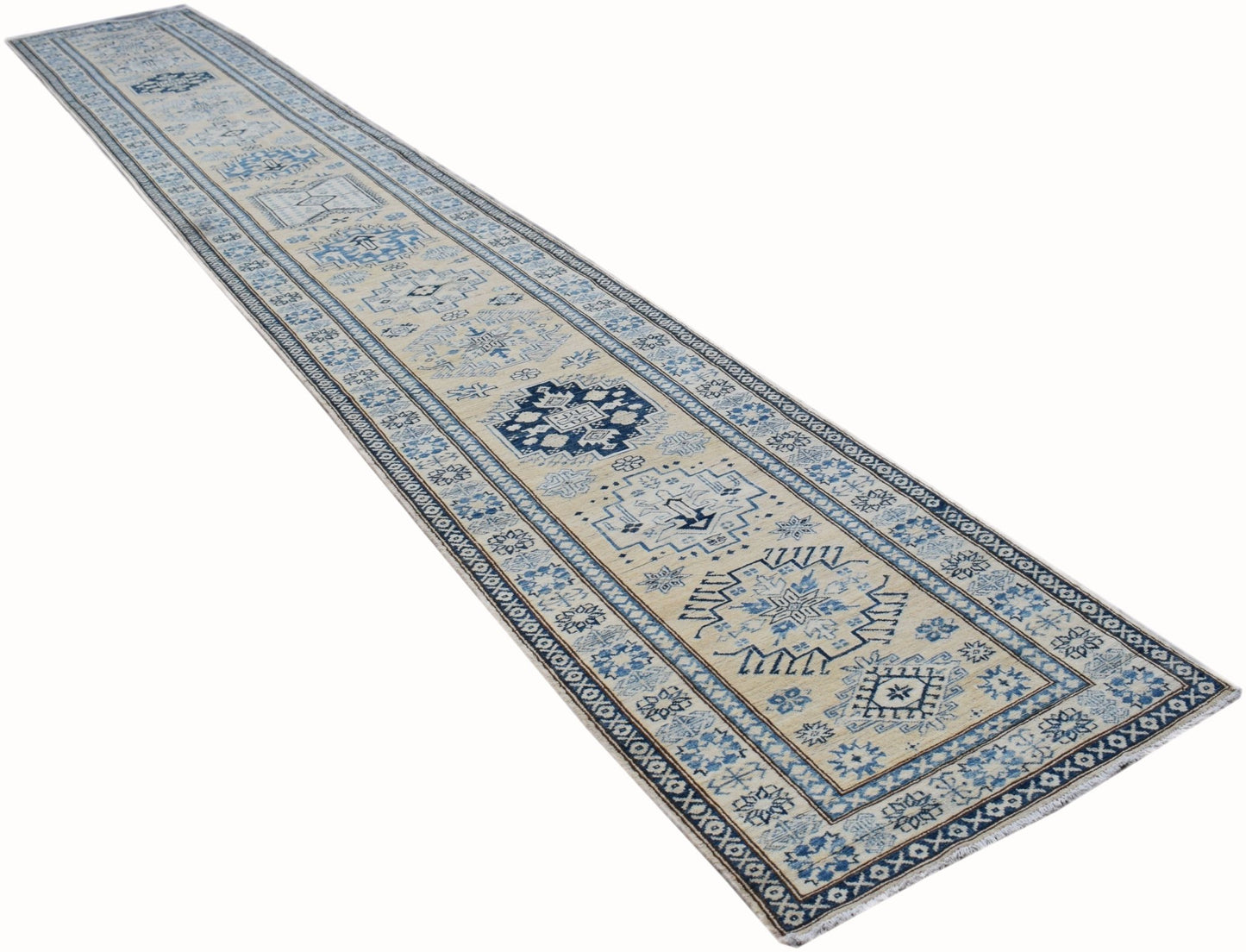A long, handmade Afghan Super Kazakh runner rug featuring traditional blue and cream geometric motifs.