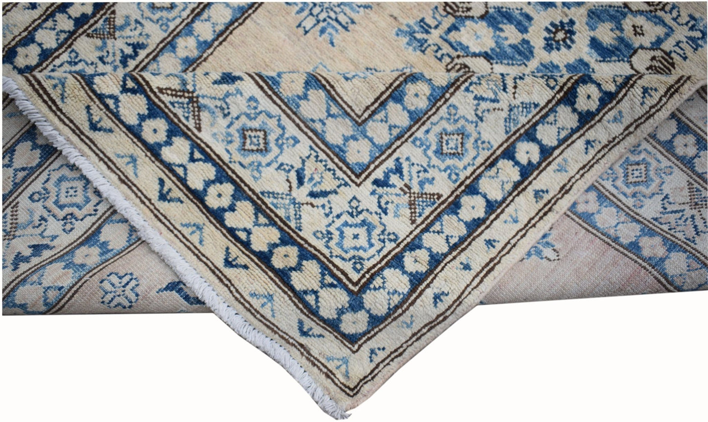 A handmade Afghan Super Kazakh runner featuring traditional blue and cream geometric patterns.