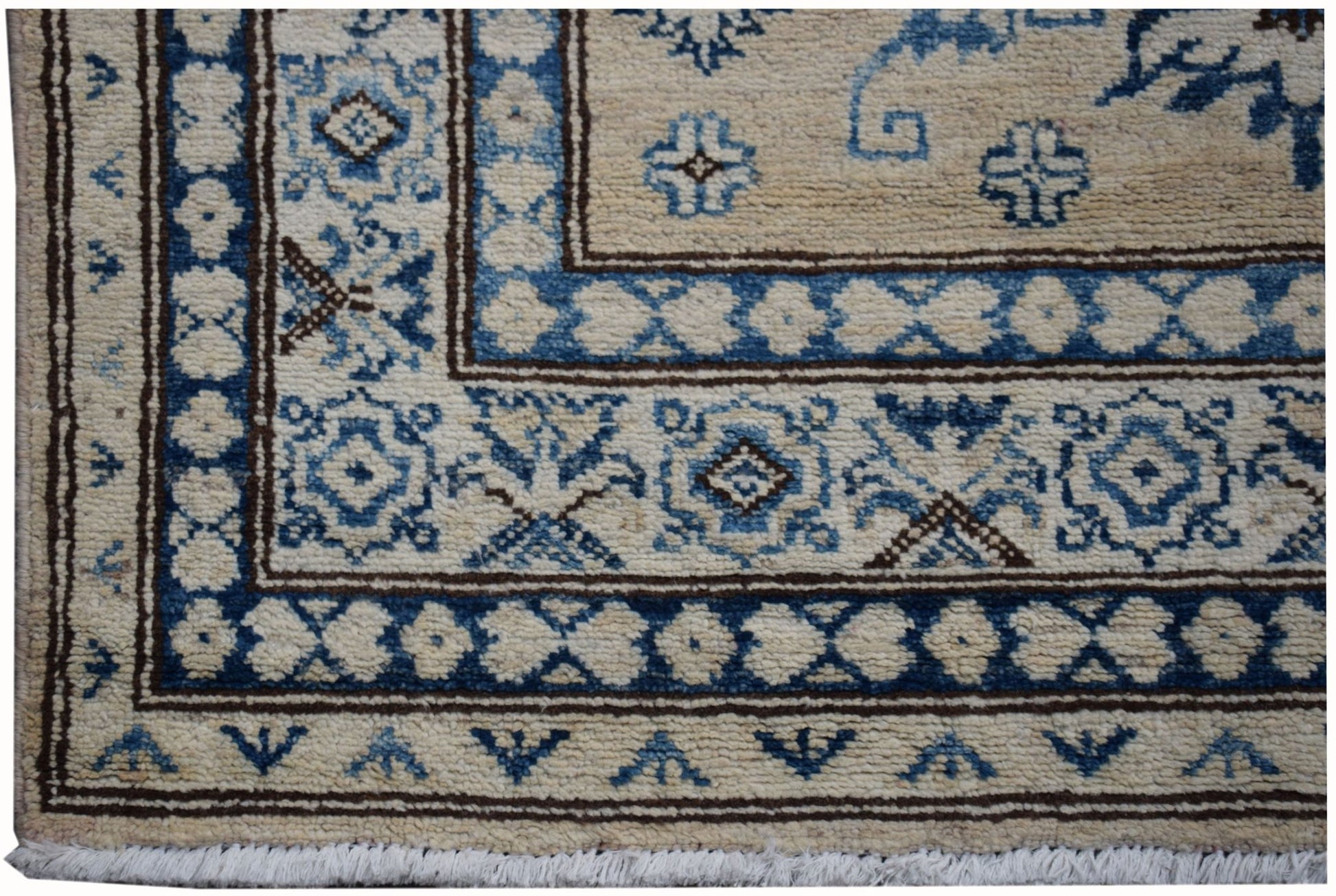 A handmade Afghan Super Kazakh runner featuring traditional blue and cream geometric patterns.