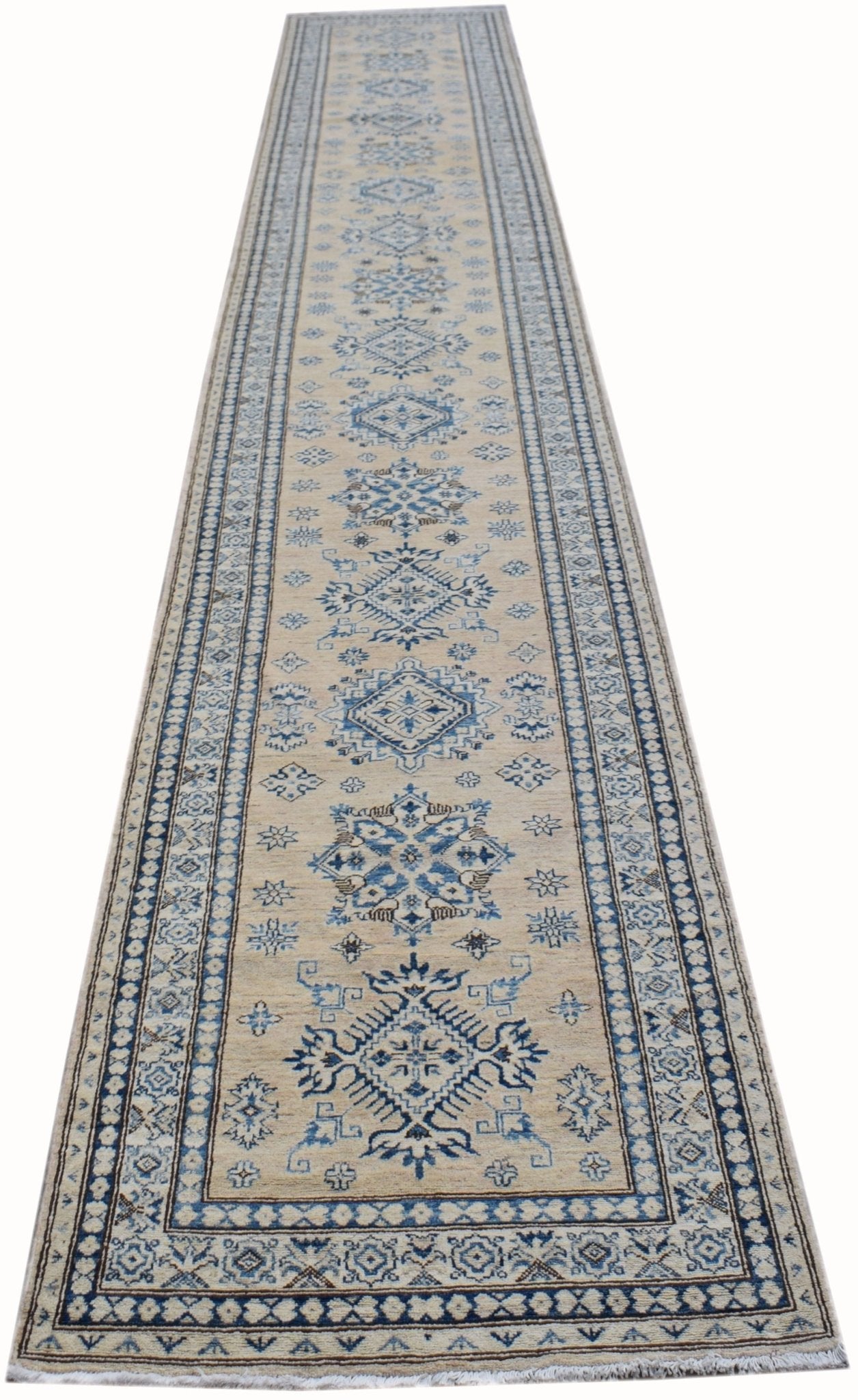 An Afghan Super Kazakh runner rug featuring traditional blue geometric motifs on a beige field.