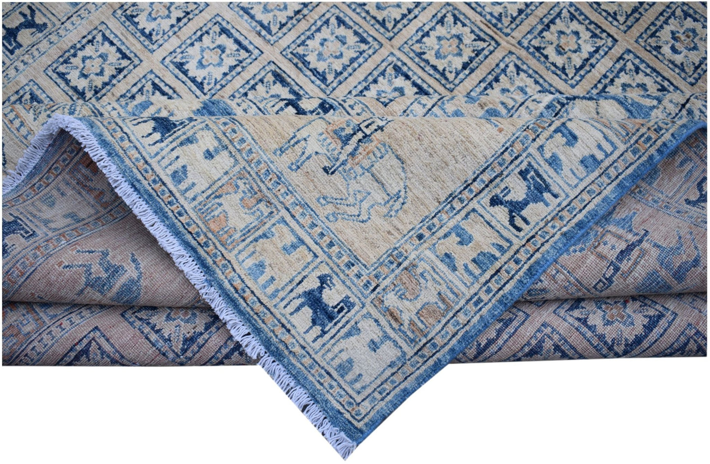 A handmade Afghan Chobi rug featuring a blue and beige geometric Pazyryk pattern with fringe.