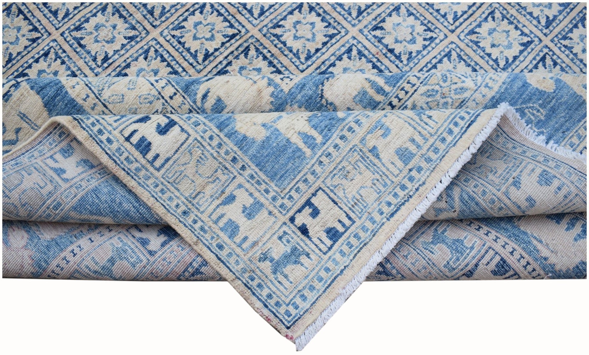 A blue and cream Afghan Chobi rug featuring a geometric diamond pattern and animal motifs.