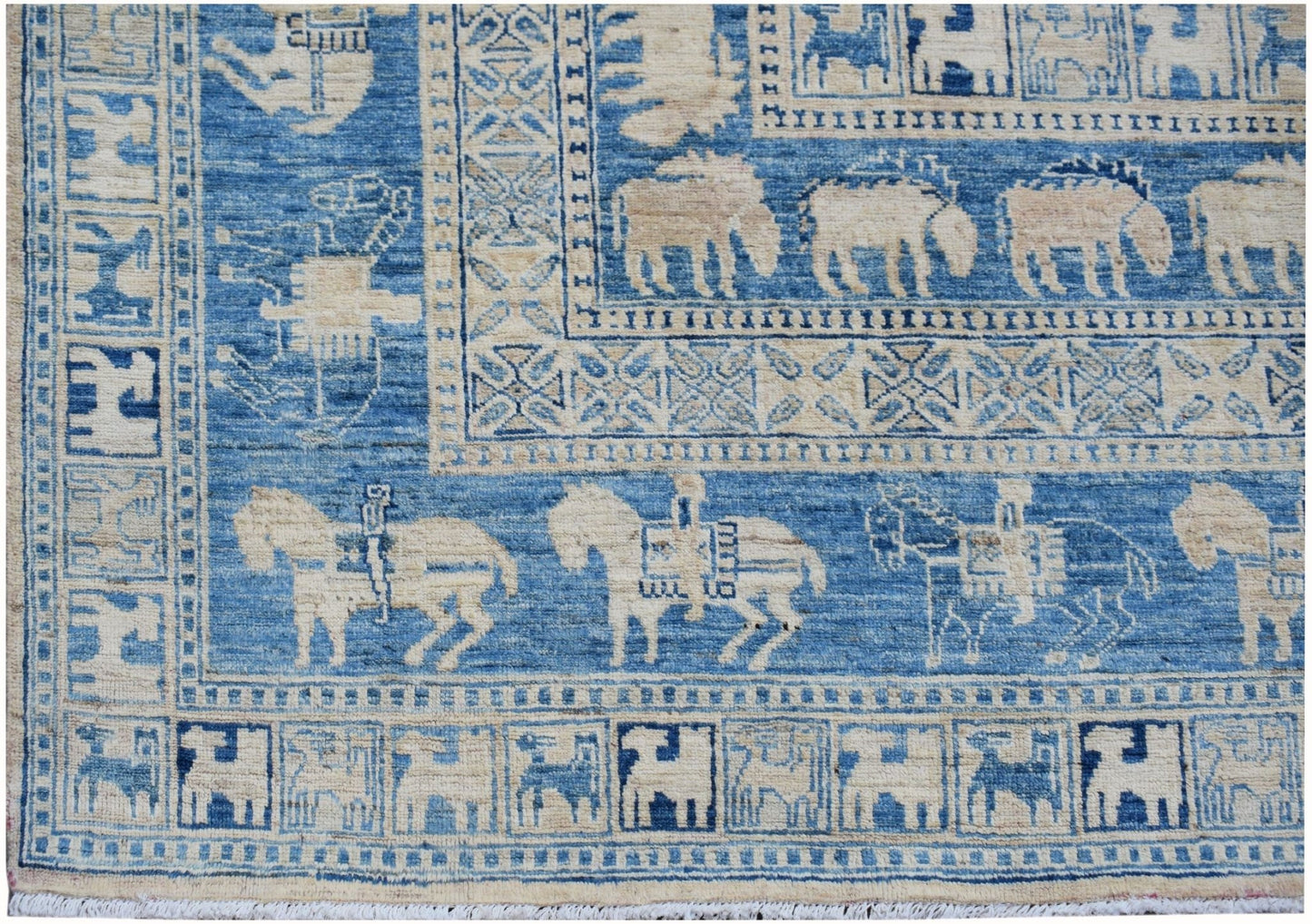 A blue and cream Afghan Chobi rug featuring traditional Pazyryk horse and rider motifs.