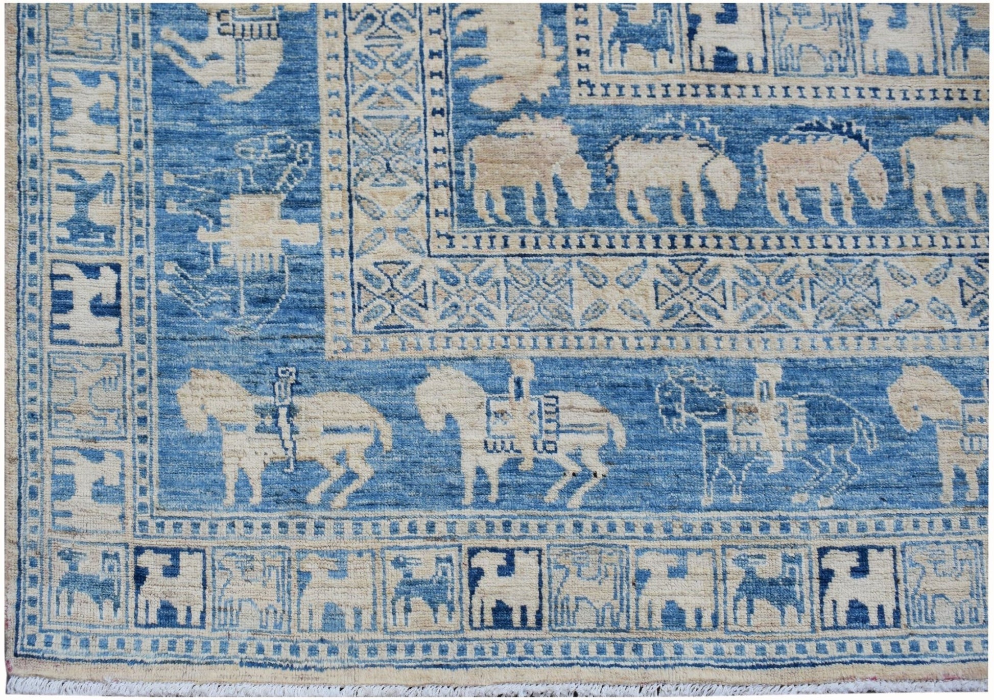 A blue and cream Afghan Chobi rug featuring traditional Pazyryk horse and rider motifs.
