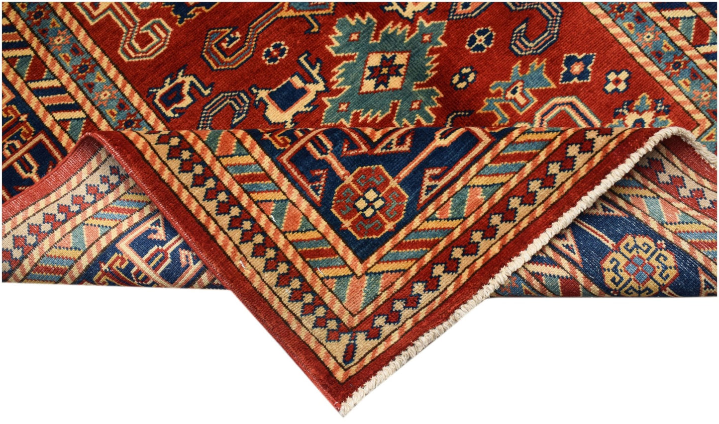 A handmade Afghan Super Kazakh rug featuring traditional geometric motifs in red and blue wool.