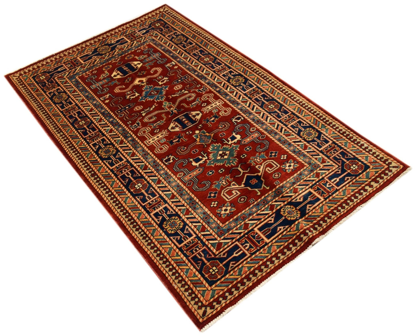 Handmade Afghan Super Kazakh rug featuring traditional geometric motifs in red, blue, and cream.