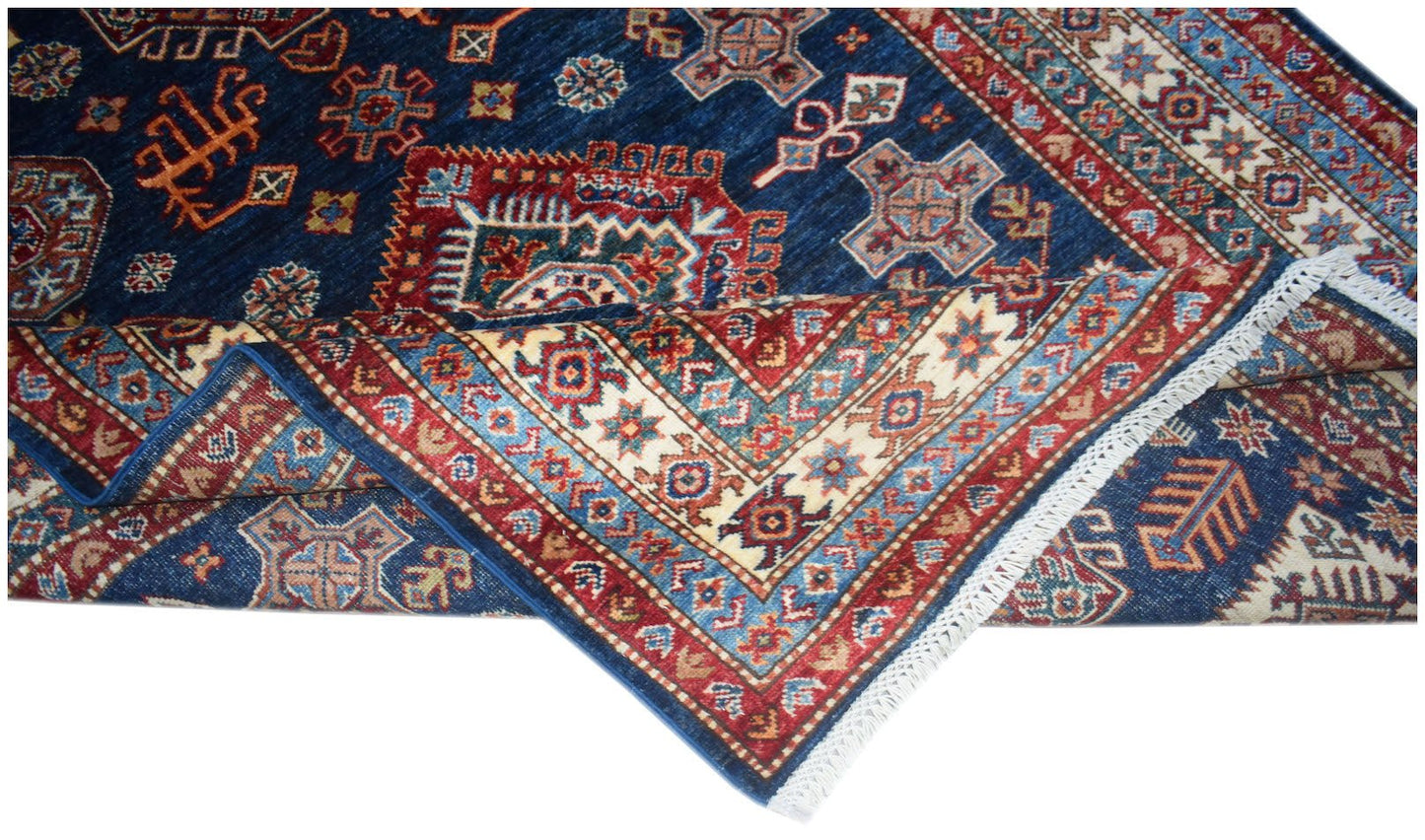 A handmade Afghan Super Kazakh rug featuring traditional geometric motifs in blue and red.