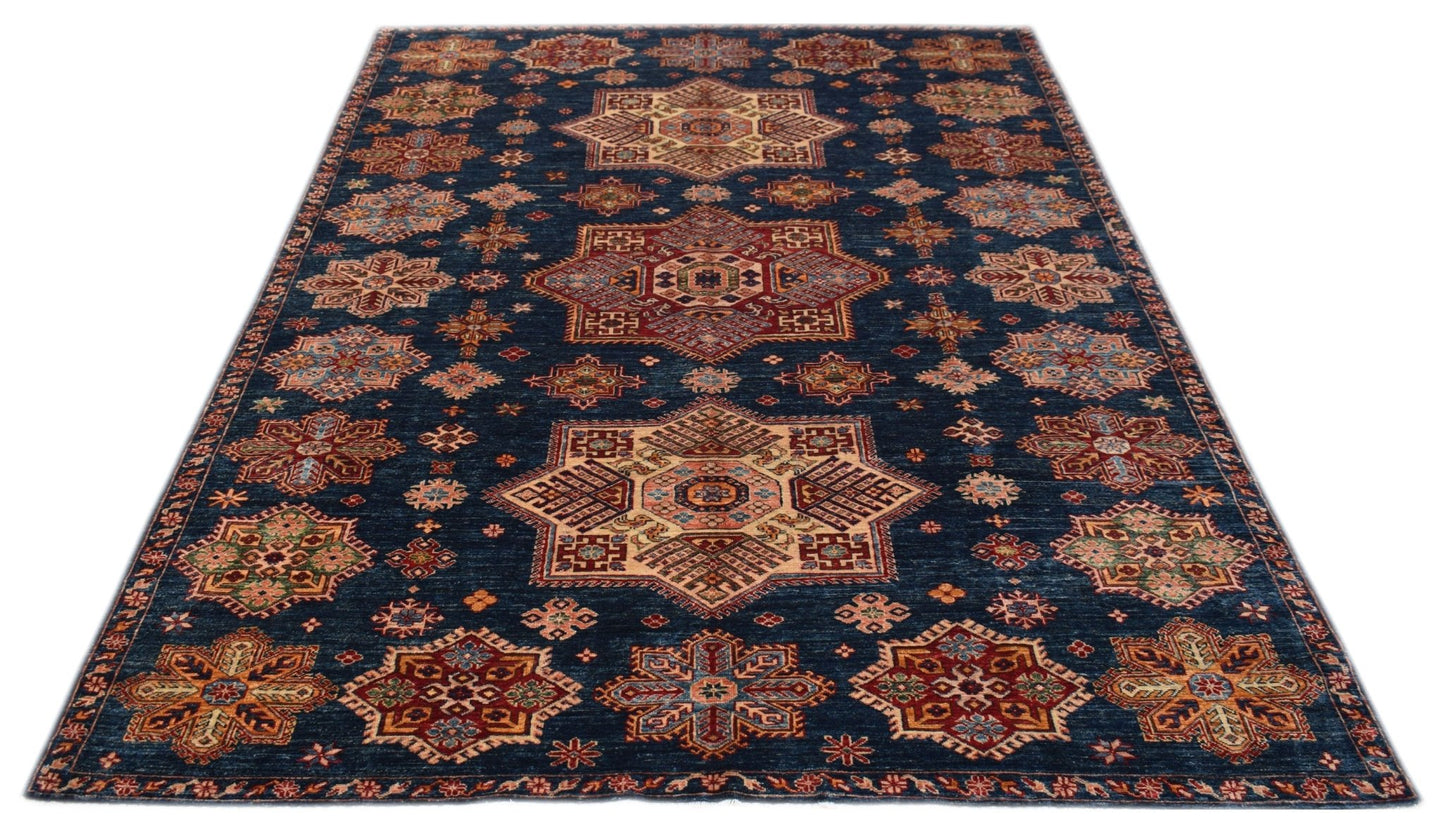 Handmade Afghan Super Kazakh rug featuring traditional geometric motifs on a deep blue background.