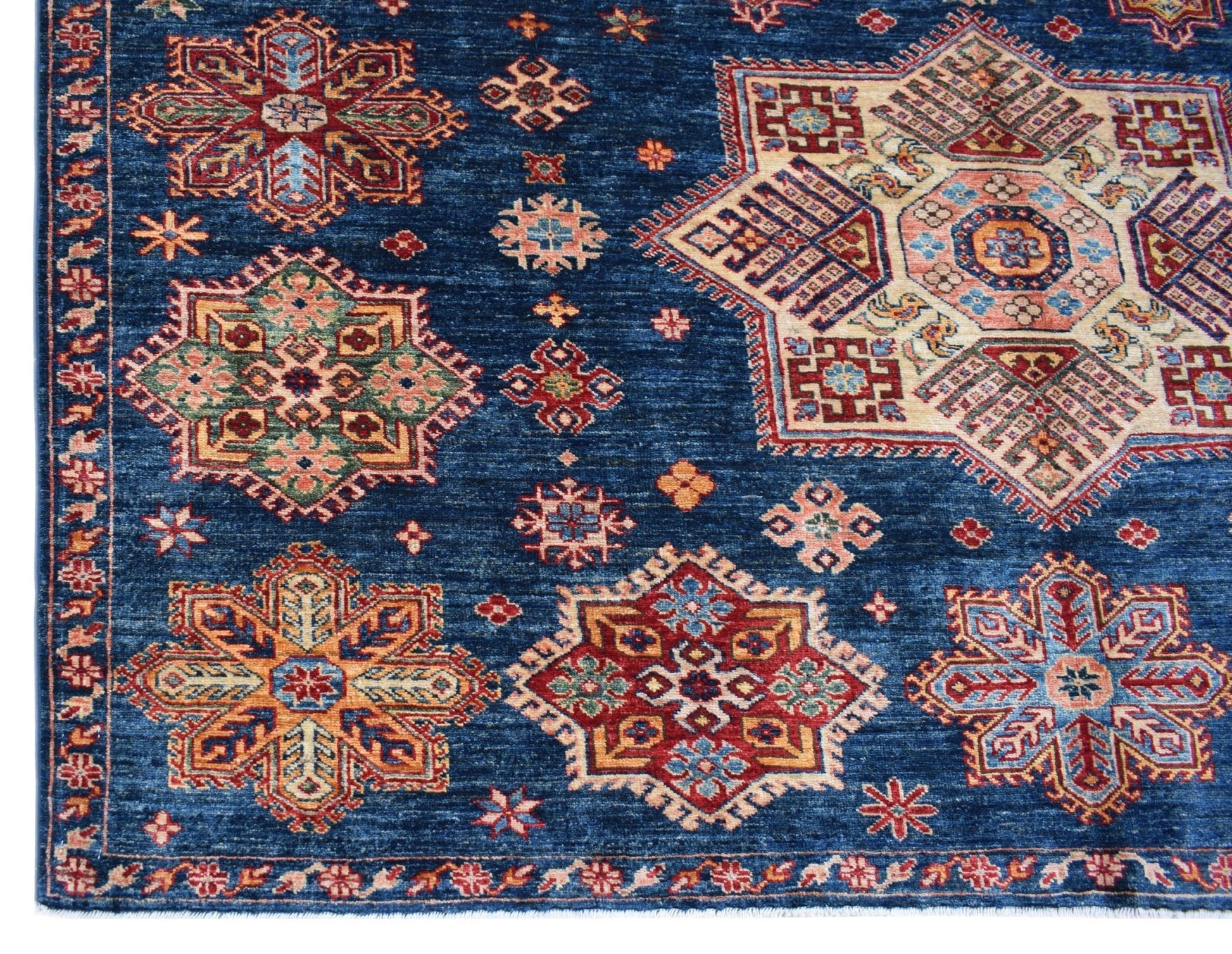 Handmade Afghan Super Kazakh rug featuring traditional geometric motifs in red and blue tones.