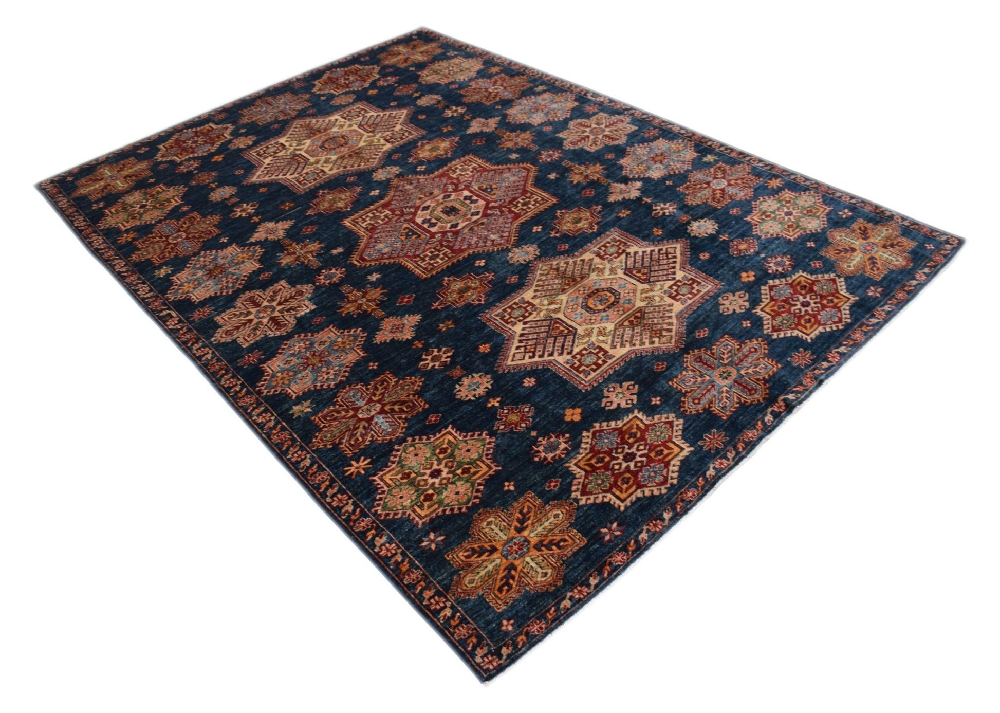 Handmade Afghan Super Kazakh rug featuring traditional geometric motifs on a deep blue background.