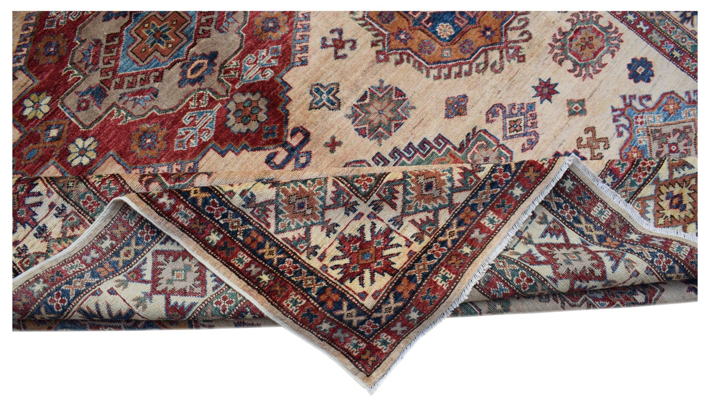 A handmade Afghan Super Kazakh rug featuring traditional geometric motifs in red, blue, and beige.