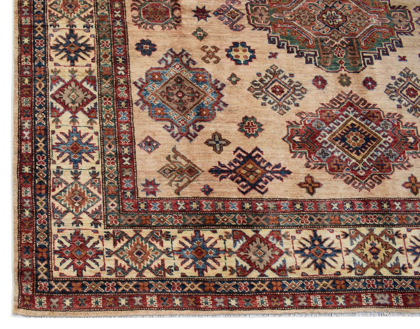 Handmade Afghan Super Kazakh rug featuring traditional geometric motifs in red, blue, and tan.
