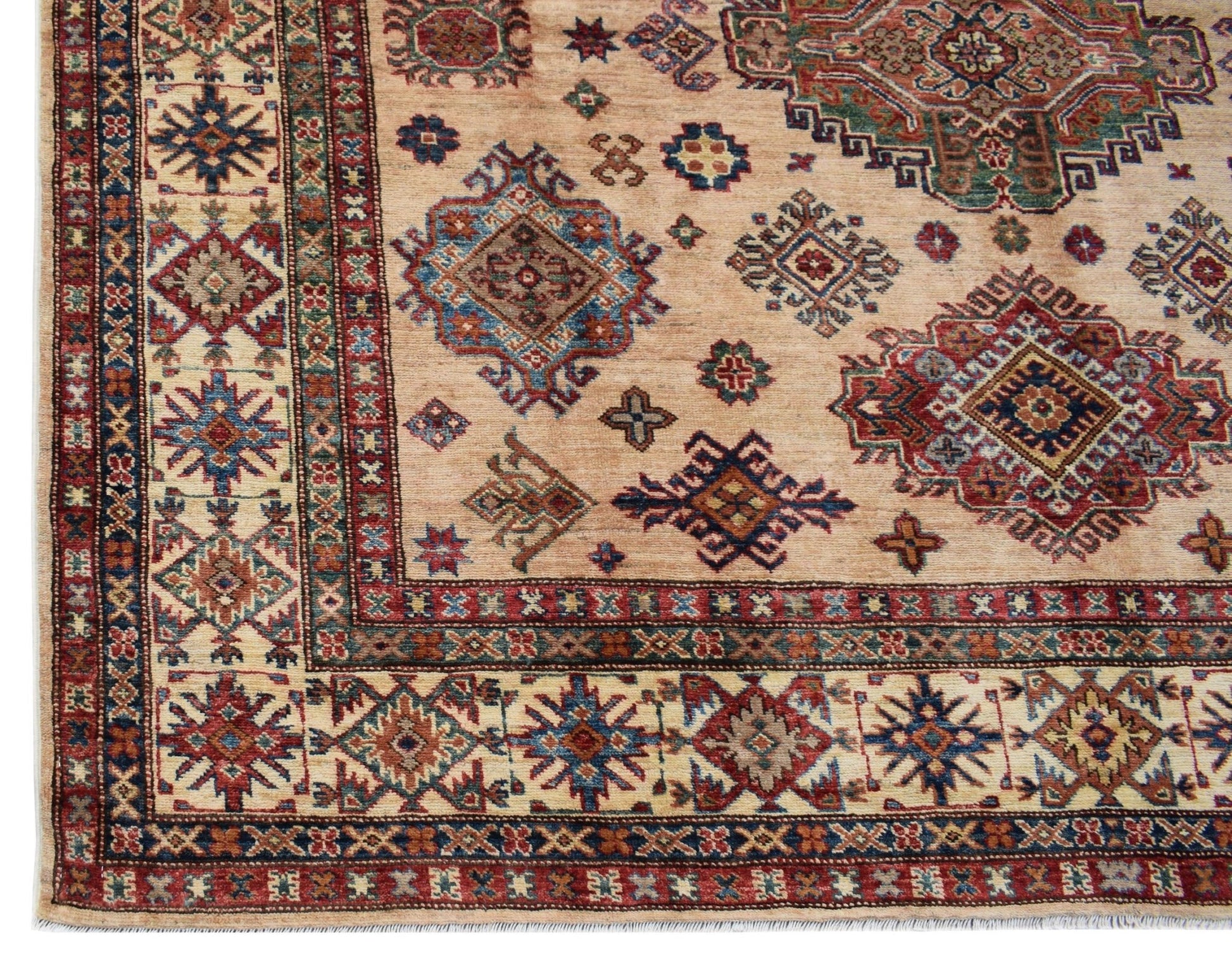 Handmade Afghan Super Kazakh rug featuring traditional geometric motifs in red, blue, and tan.