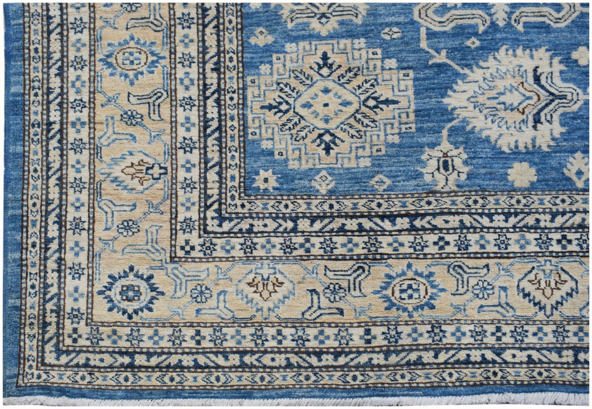 Handmade Afghan Super Kazakh rug featuring traditional geometric motifs in blue and cream tones.