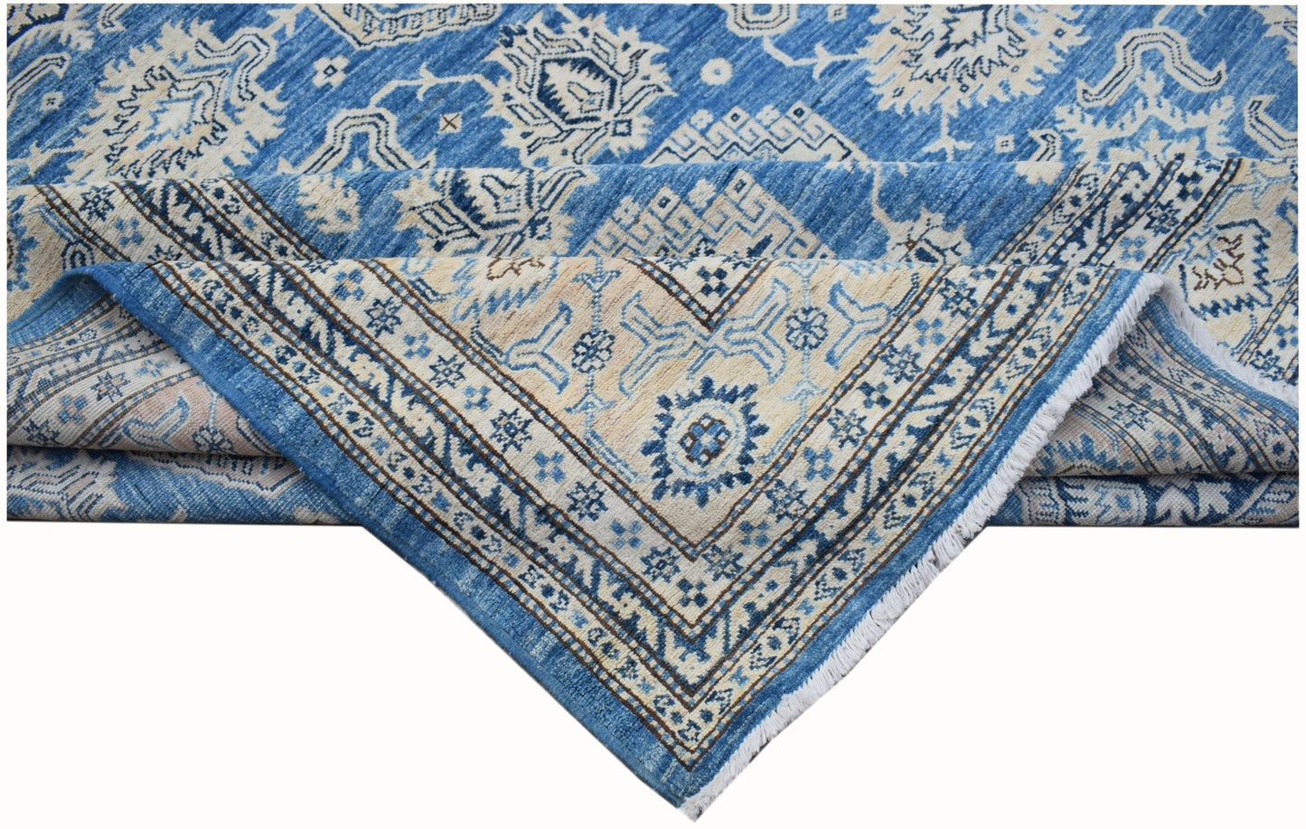 A handmade Afghan Super Kazakh rug featuring traditional blue and cream geometric patterns.
