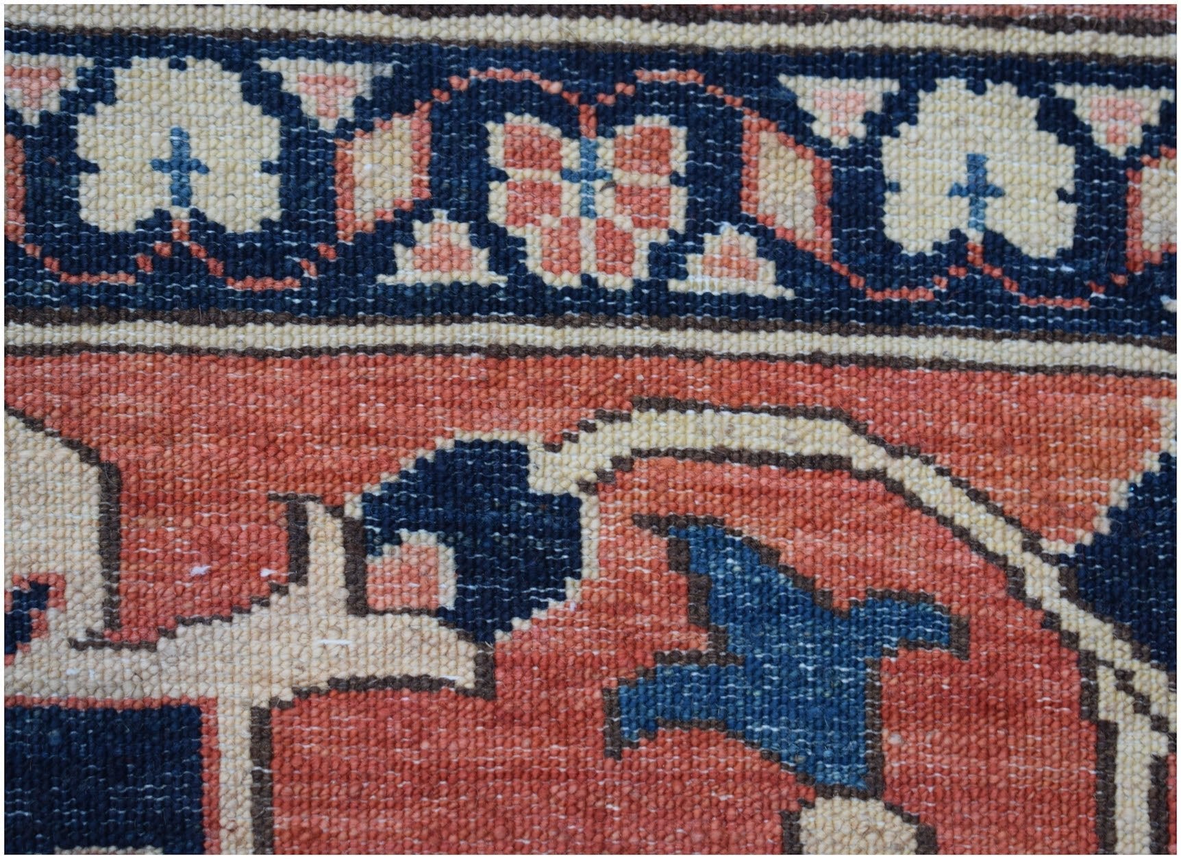 A close-up of an Afghan Super Kazakh rug featuring traditional geometric motifs in red and blue.