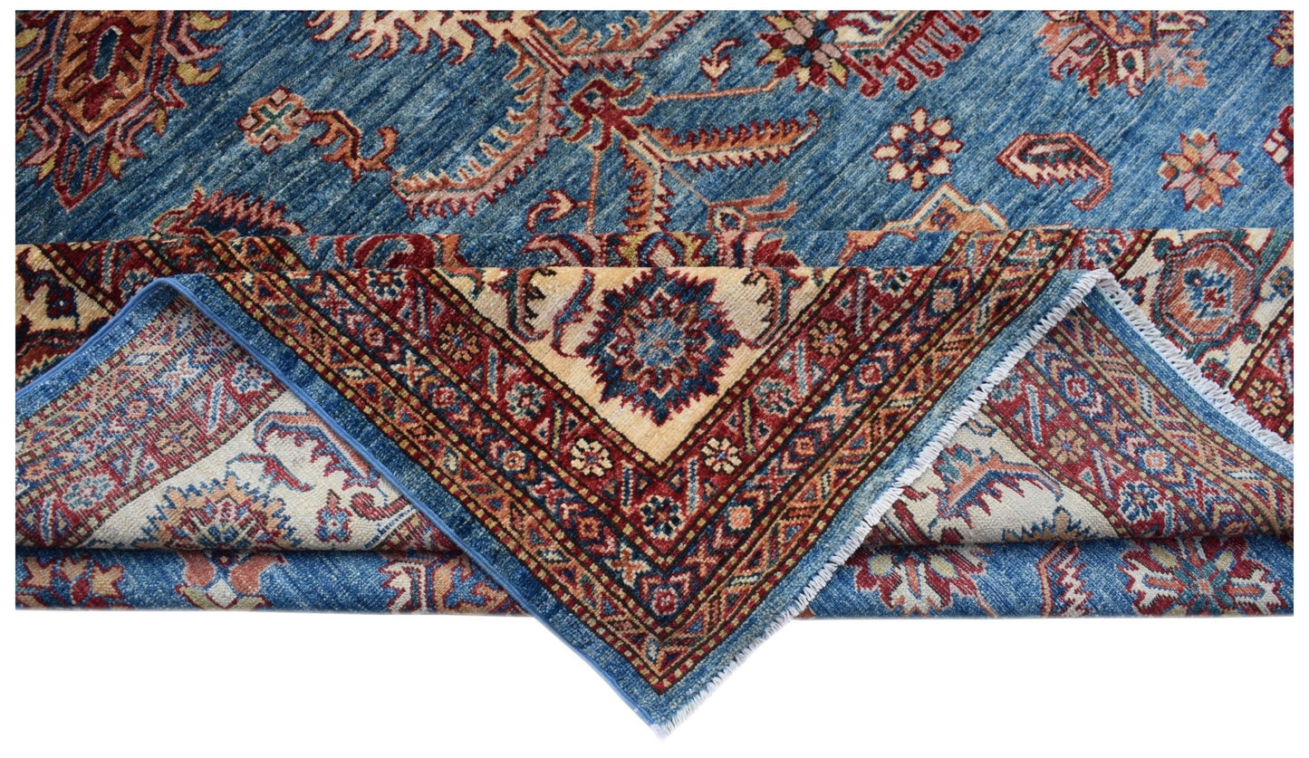 A handmade Afghan Super Kazakh rug featuring traditional blue, red, and cream geometric patterns.