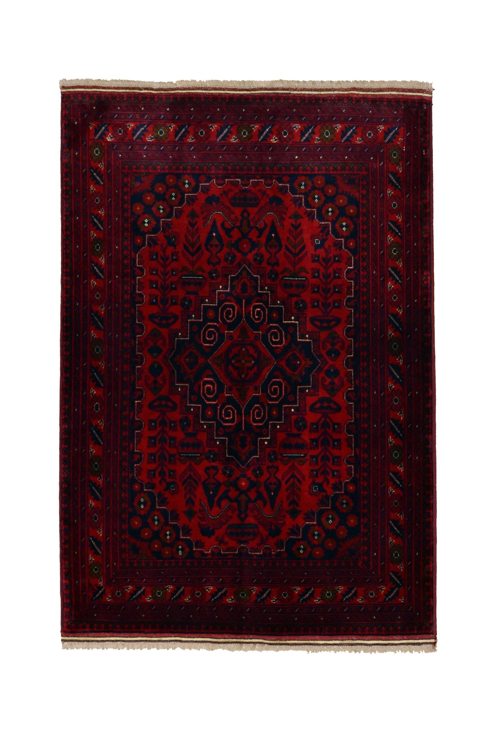 A handmade Afghan Biljik rug featuring a deep red and blue geometric pattern with fringe ends.