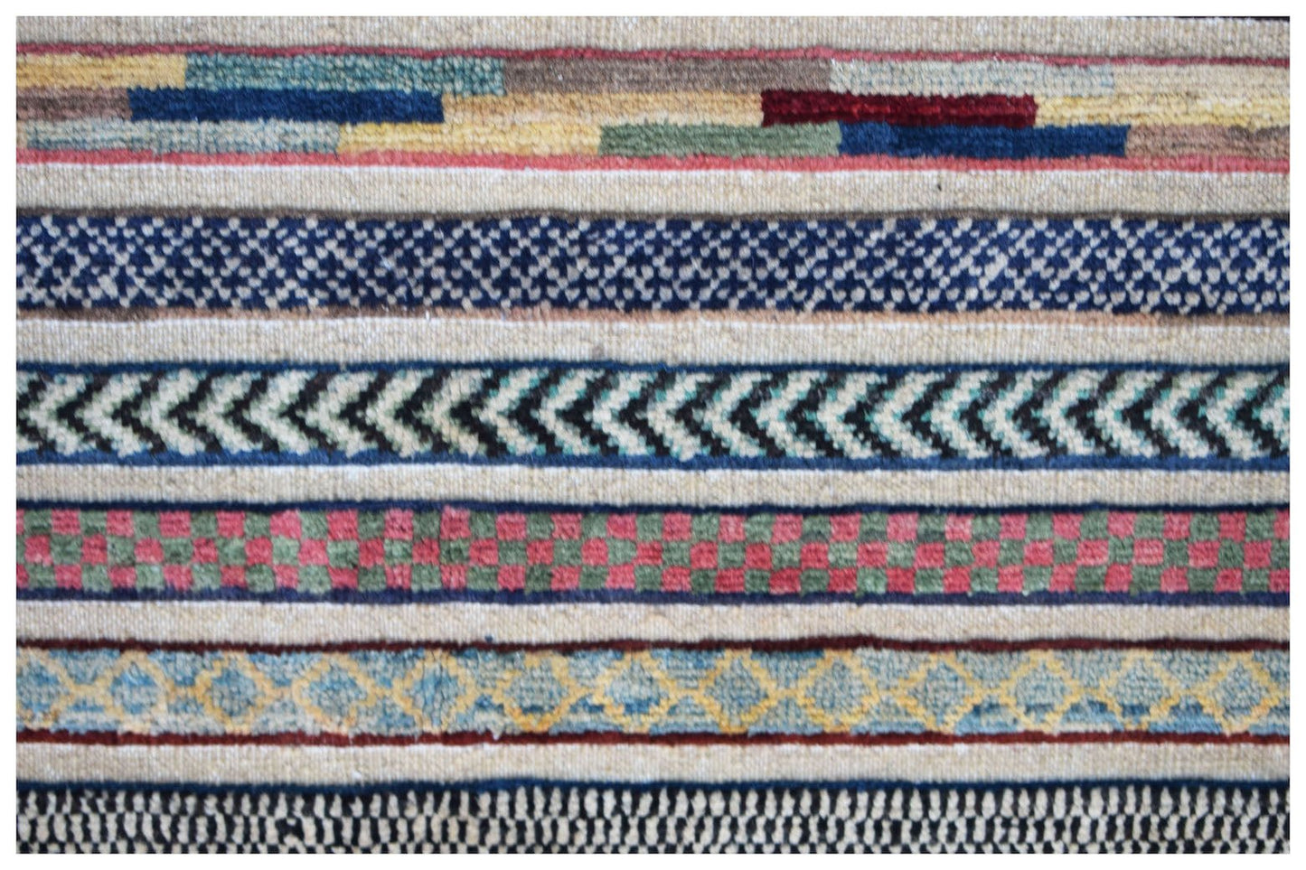 Handmade Afghan runner rug featuring a series of colorful, patterned horizontal bands.