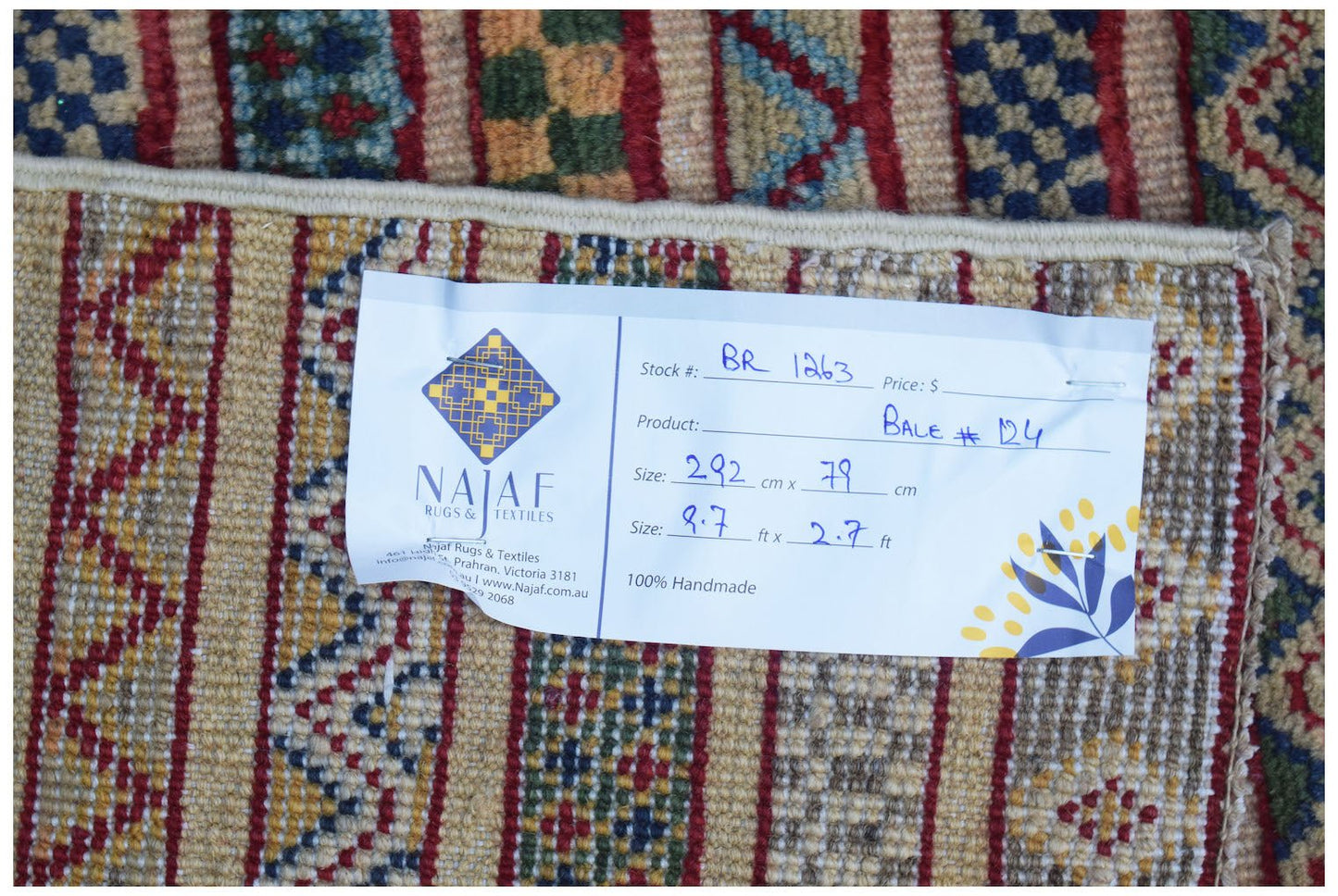 A handmade Afghan Yekta runner featuring a geometric pattern in warm earth tones.