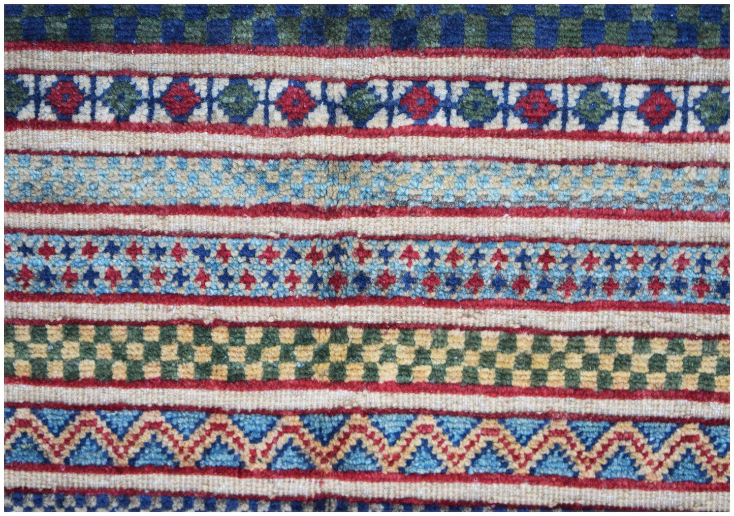 A handmade Afghan runner featuring horizontal bands of geometric patterns in vibrant colors.