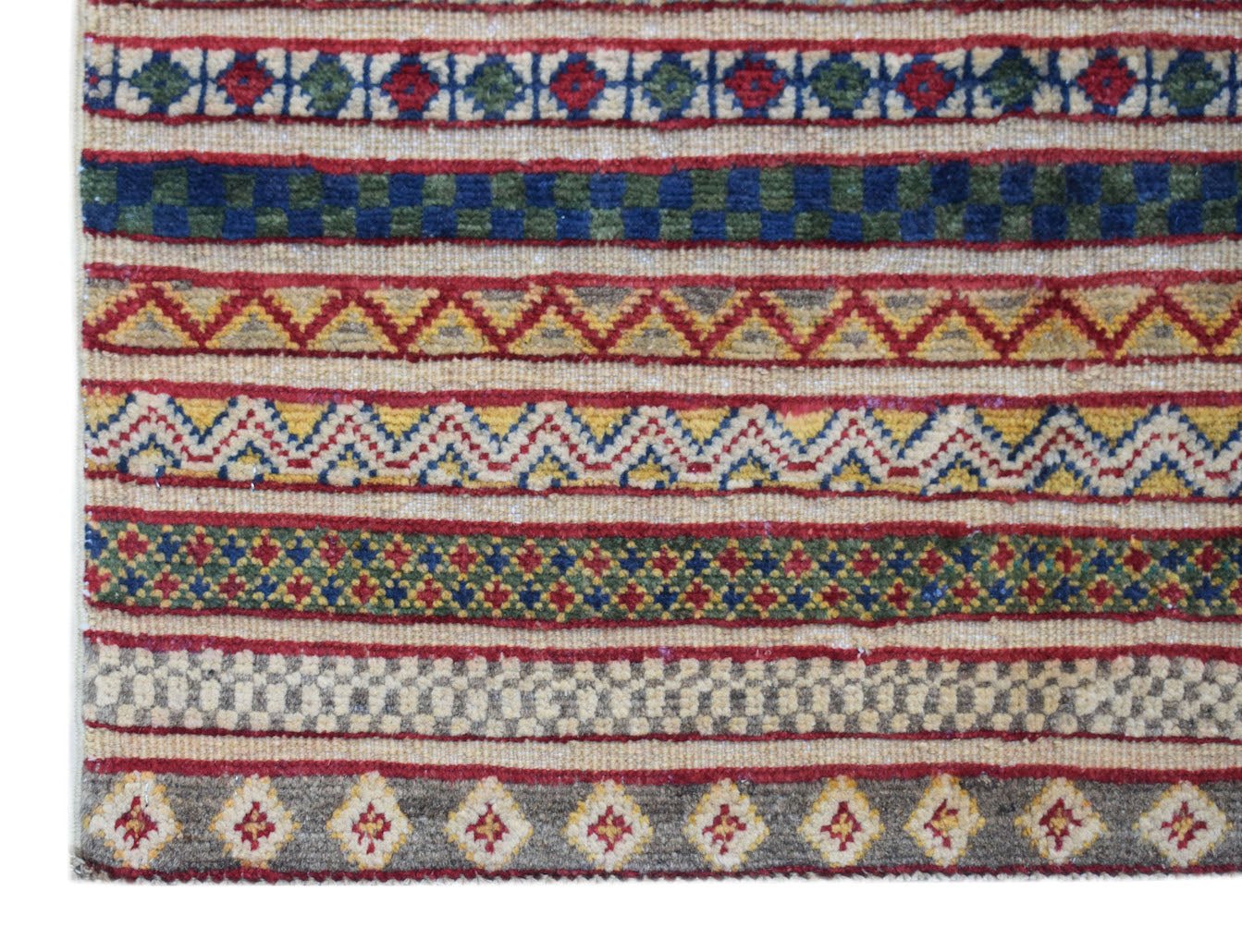 Handmade Afghan runner rug featuring horizontal bands of geometric patterns in red, blue, and gold.