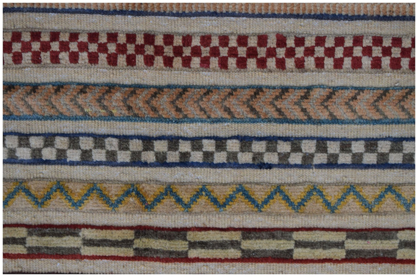 An Afghan Yekta runner featuring horizontal bands of geometric patterns in wool on a cotton base.