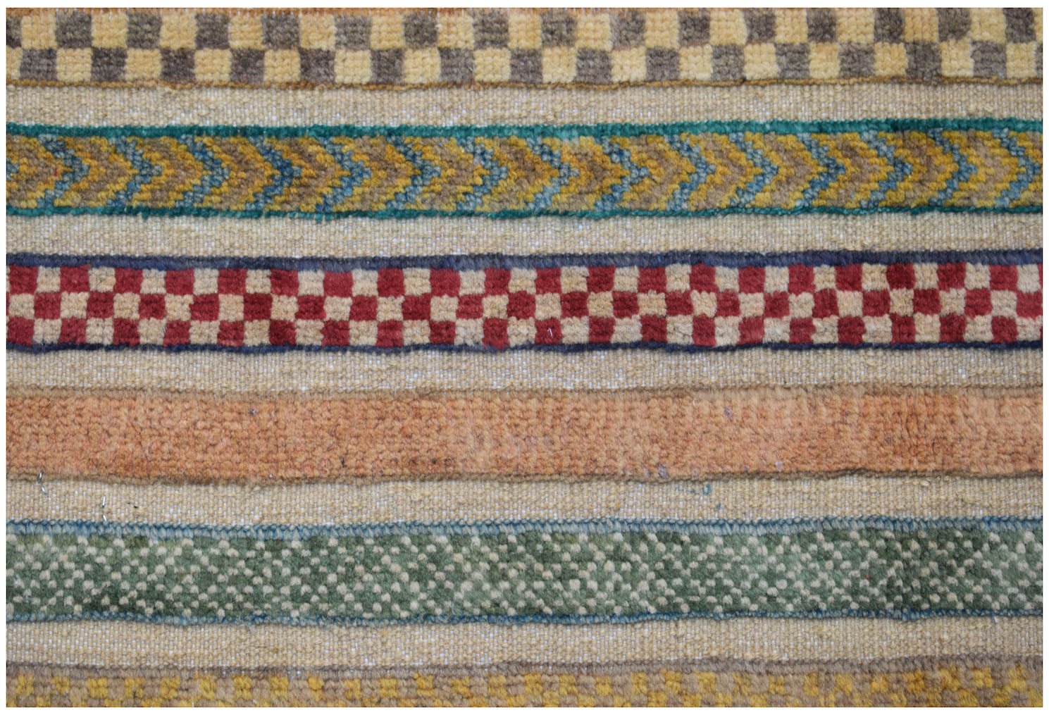 A handmade Afghan runner featuring horizontal bands of geometric patterns in varied colors.
