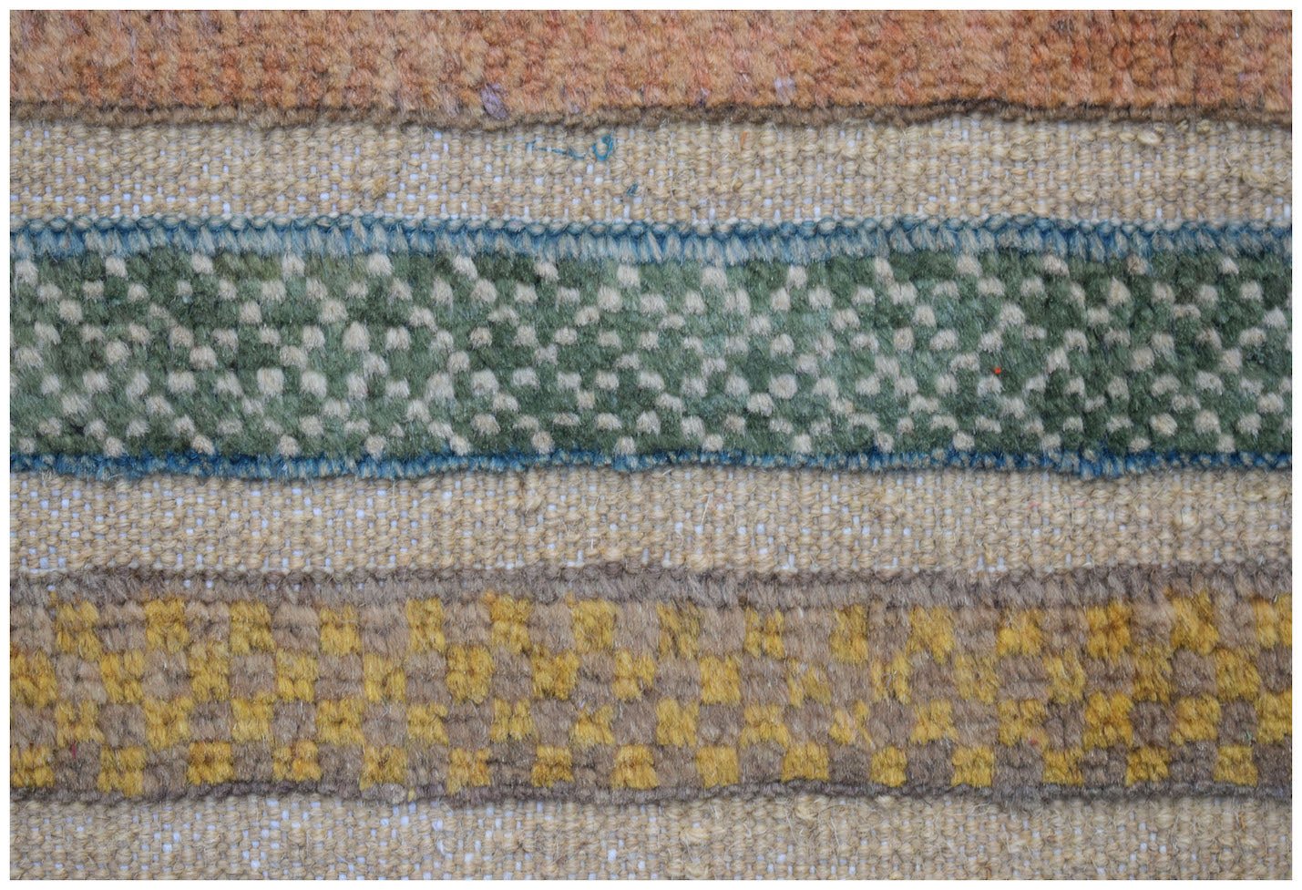 A close-up of an Afghan Yekta runner featuring horizontal bands of textured wool in earthy tones.