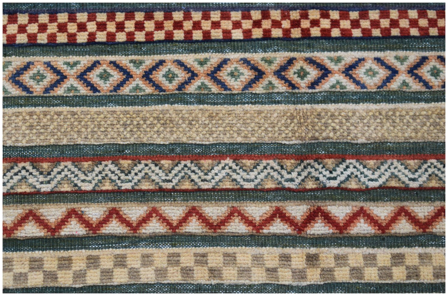 Handmade Afghan runner rug featuring horizontal bands of geometric patterns in wool.